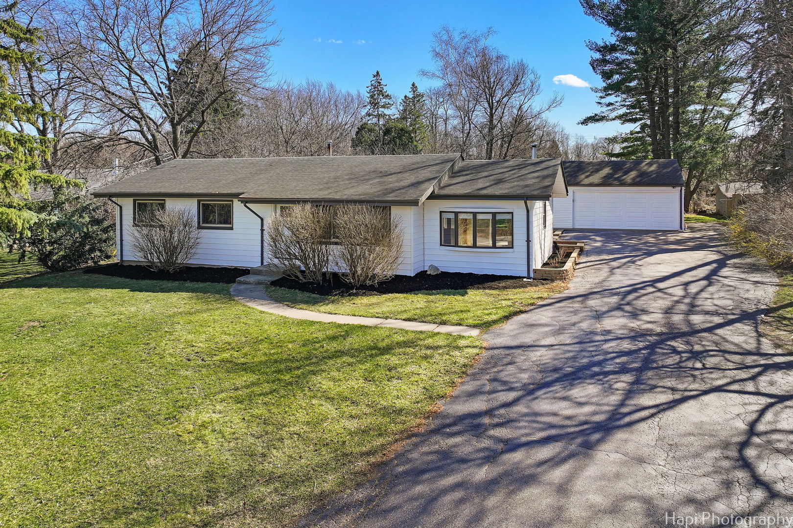 2217 Palatine Road Inverness, IL 60067 - Photo 23 of 28 a front view of a house with a yard and garage