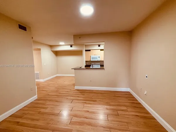 a view of a kitchen with wooden floor