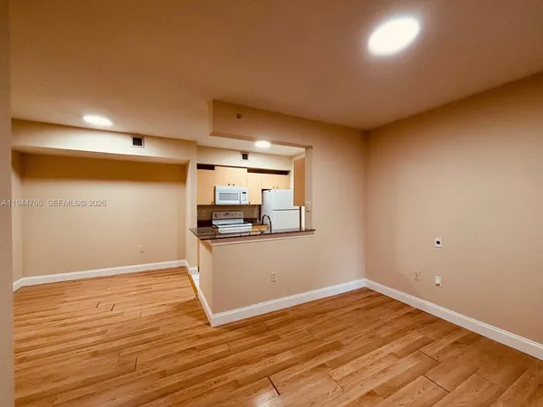 a view of a room with wooden floor