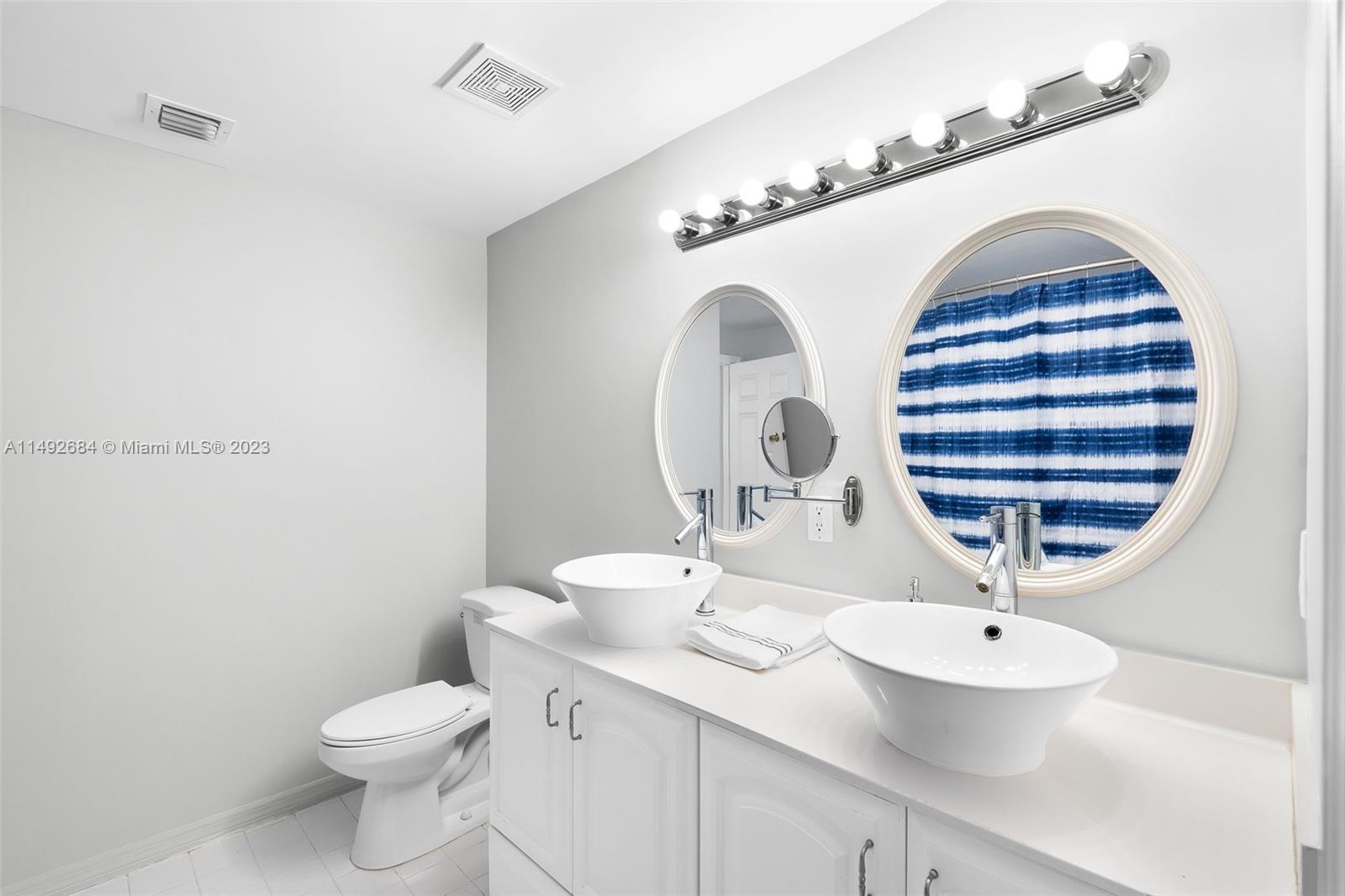 5893 Williamson Road Jupiter, FL 33458 - Photo 12 of 31 a bathroom with a sink and a mirror