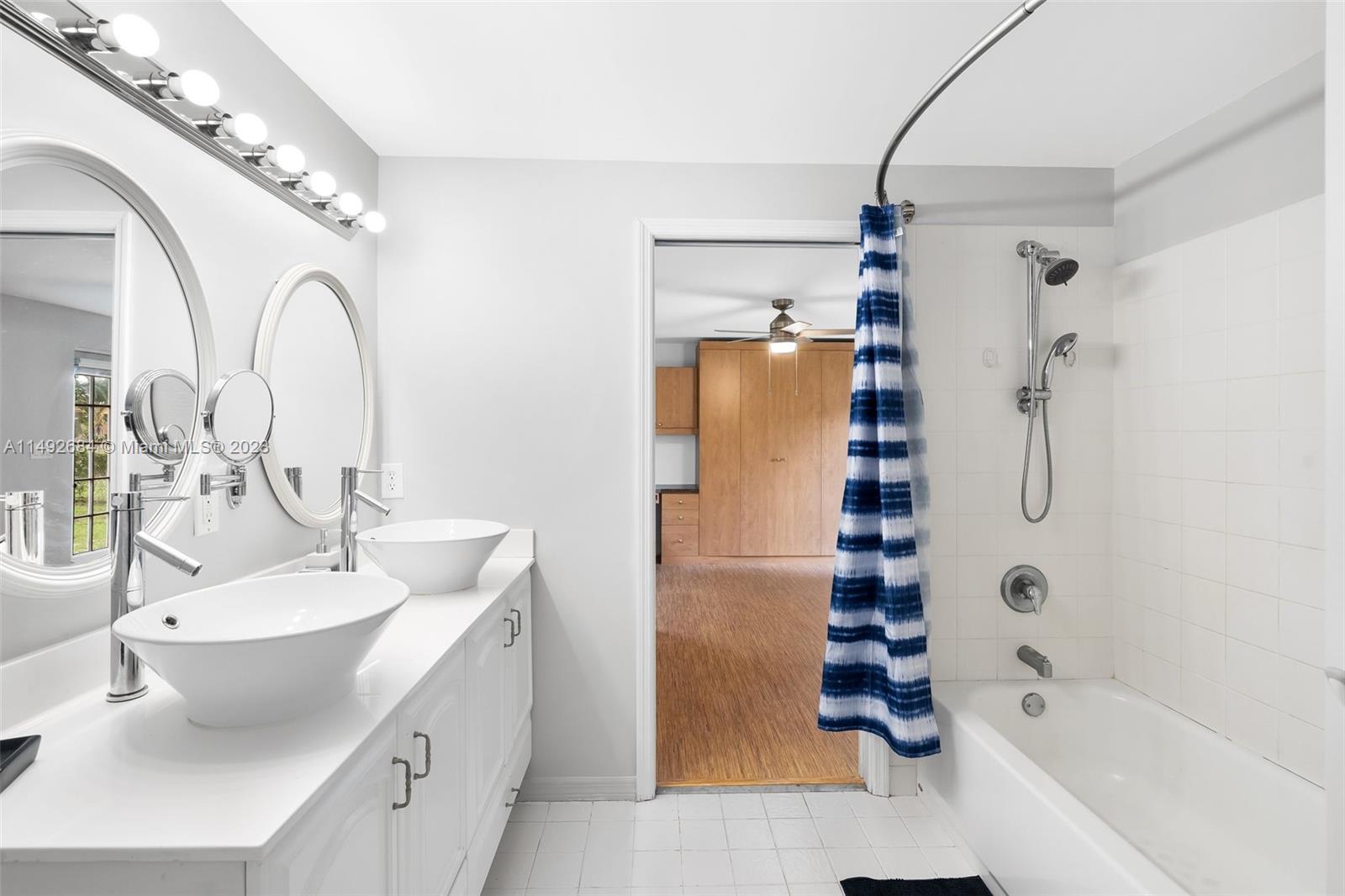 5893 Williamson Road Jupiter, FL 33458 - Photo 13 of 31 a bathroom with a tub sink and mirror