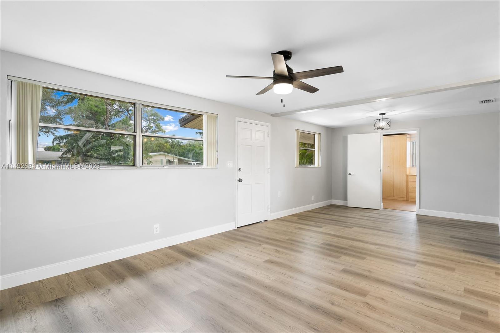 5893 Williamson Road Jupiter, FL 33458 - Photo 14 of 31 a view of empty room with wooden floor and fan