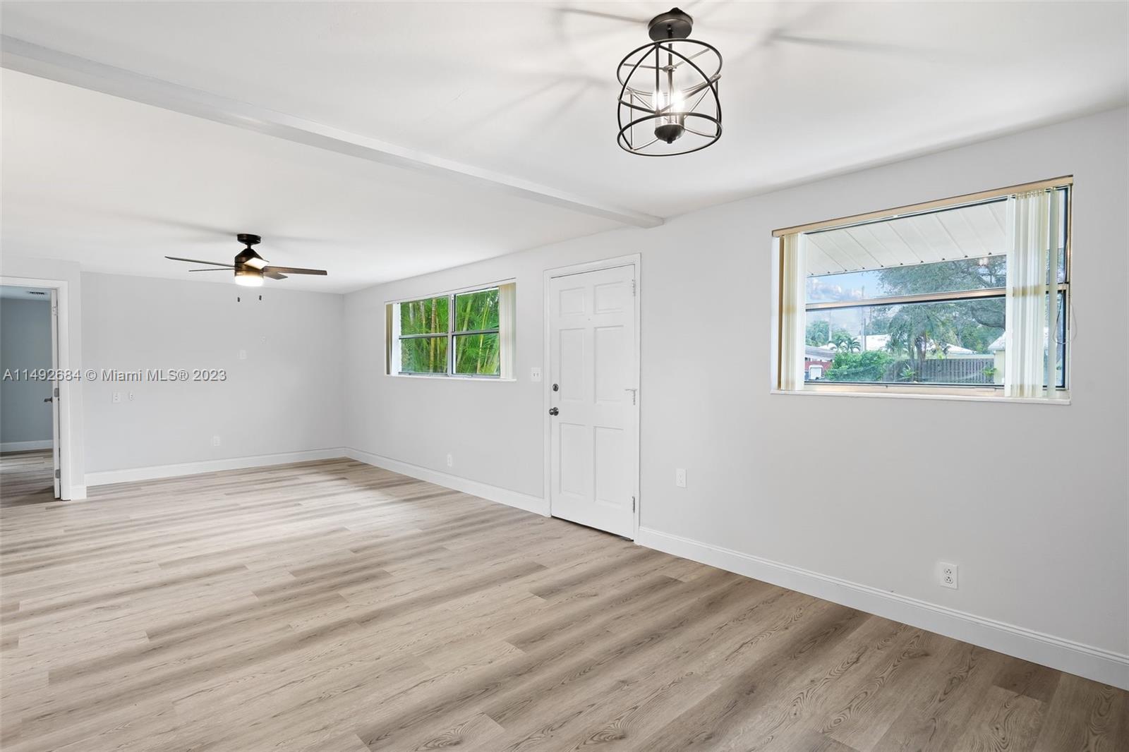 5893 Williamson Road Jupiter, FL 33458 - Photo 15 of 31 a view of an empty room with window and wooden floor