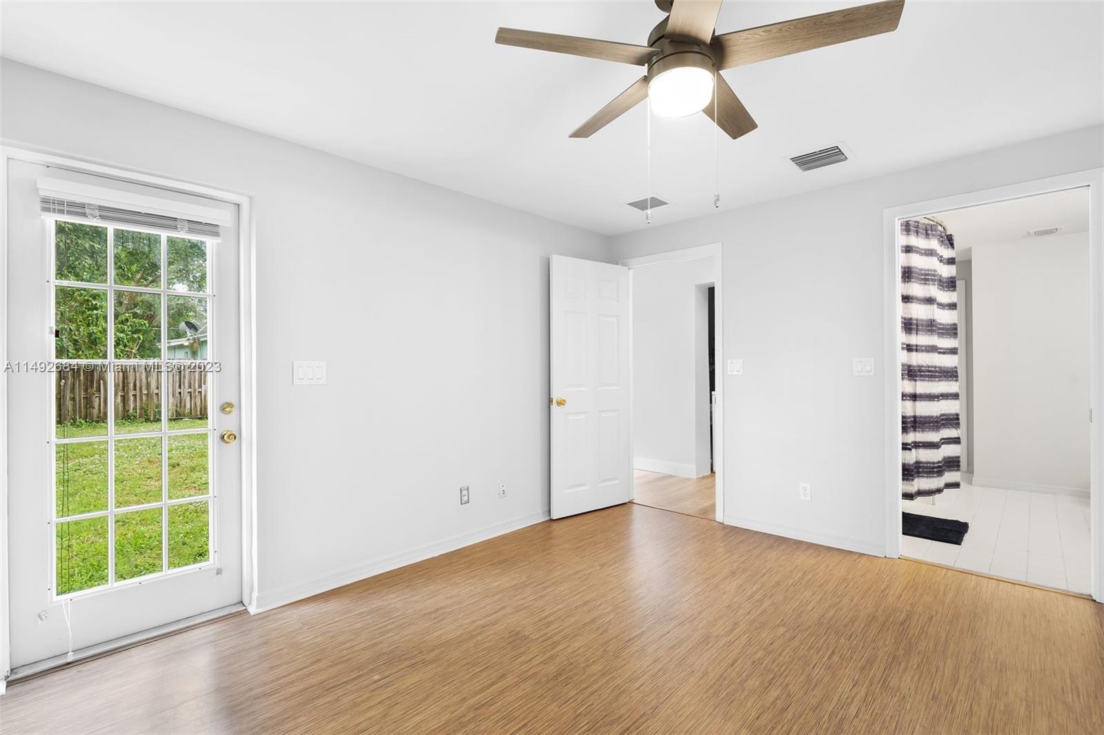 5893 Williamson Road Jupiter, FL 33458 - Photo 17 of 31 wooden floor in an empty room with a window