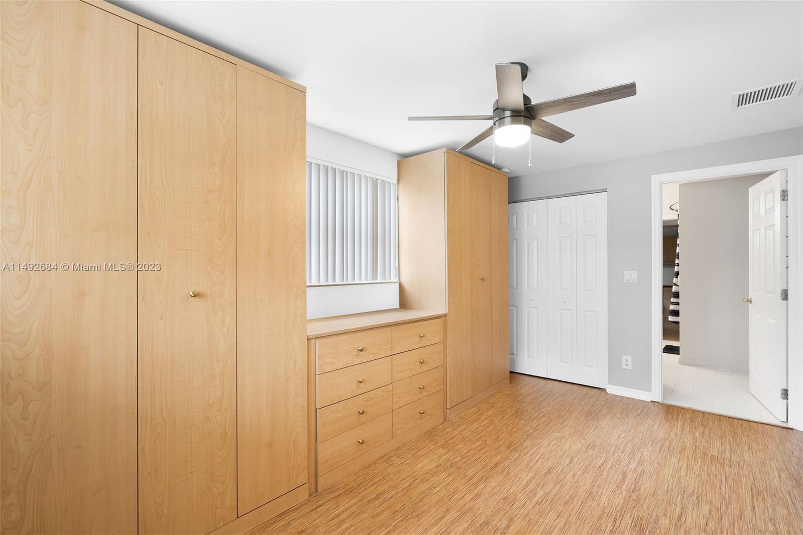 5893 Williamson Road Jupiter, FL 33458 - Photo 19 of 31 a view of empty room with wooden floor and fan