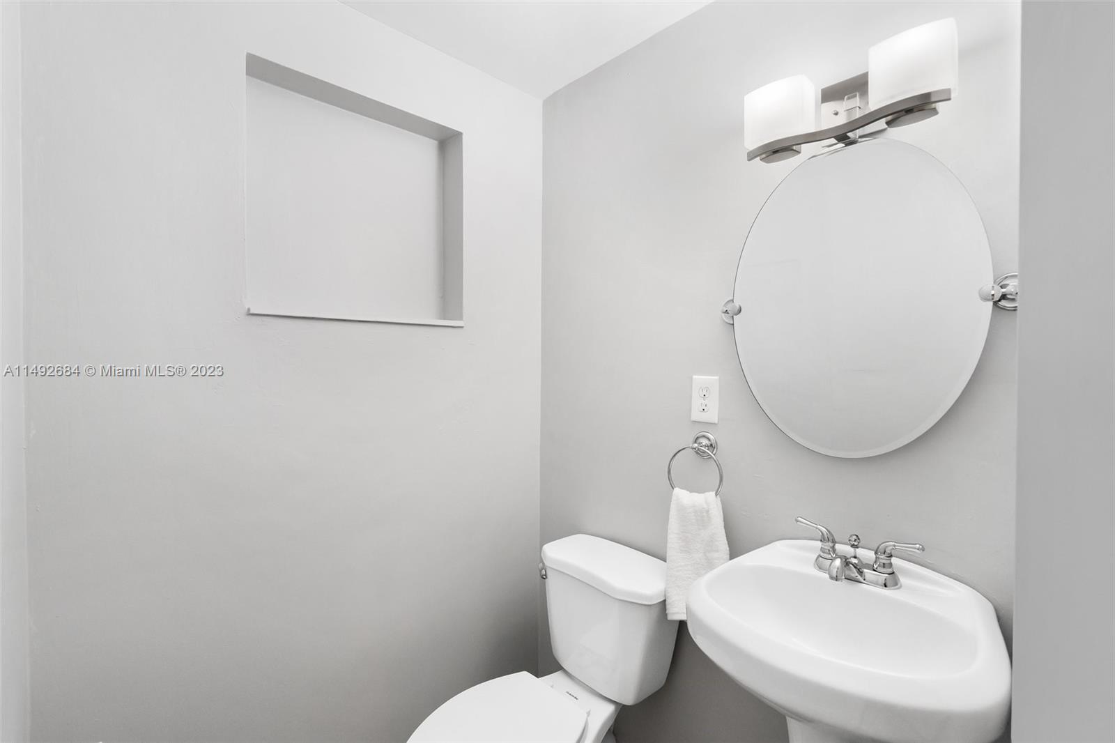 5893 Williamson Road Jupiter, FL 33458 - Photo 20 of 31 a bathroom with a toilet sink and mirror