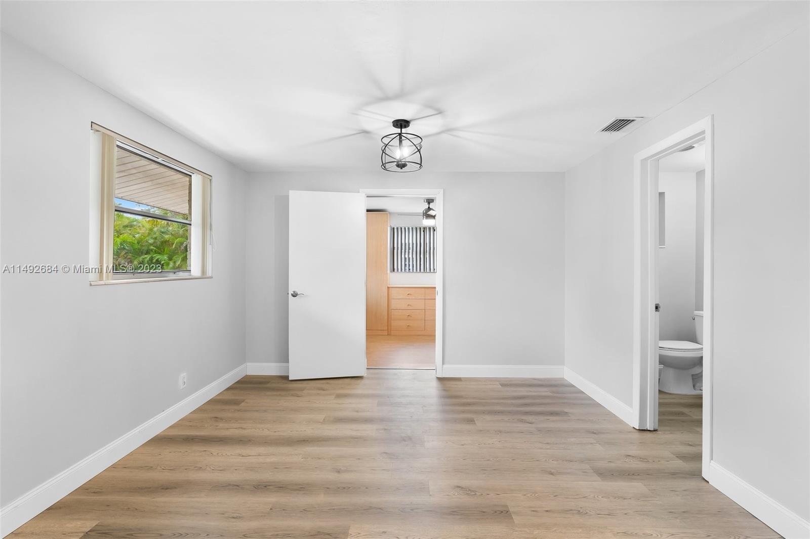 5893 Williamson Road Jupiter, FL 33458 - Photo 21 of 31 wooden floor in an empty room with a window