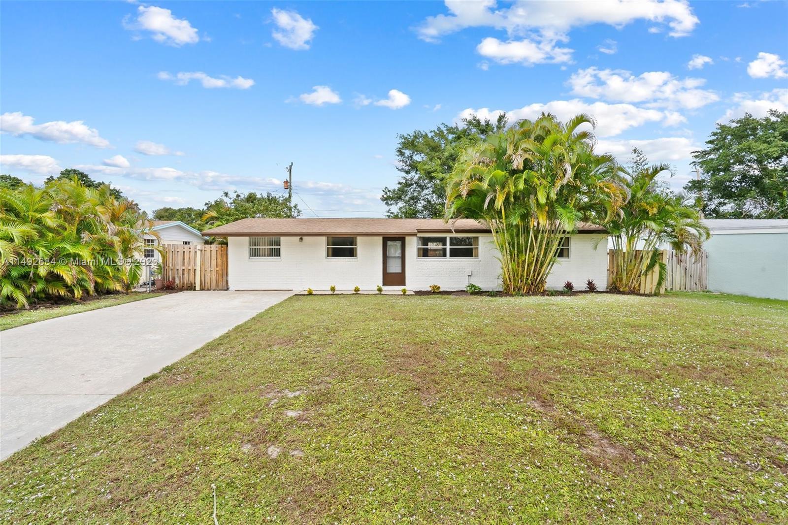 5893 Williamson Road Jupiter, FL 33458 - Photo 24 of 31 a front view of a house with a garden