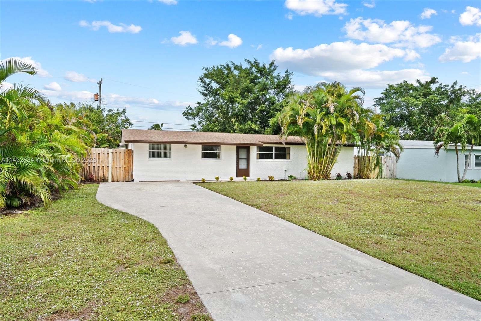5893 Williamson Road Jupiter, FL 33458 - Photo 25 of 31 a front view of a house with a garden