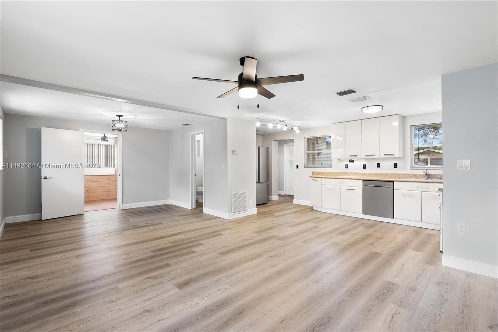 5893 Williamson Road Jupiter, FL 33458 - Photo 3 of 31 a view of a kitchen with a sink and a refrigerator