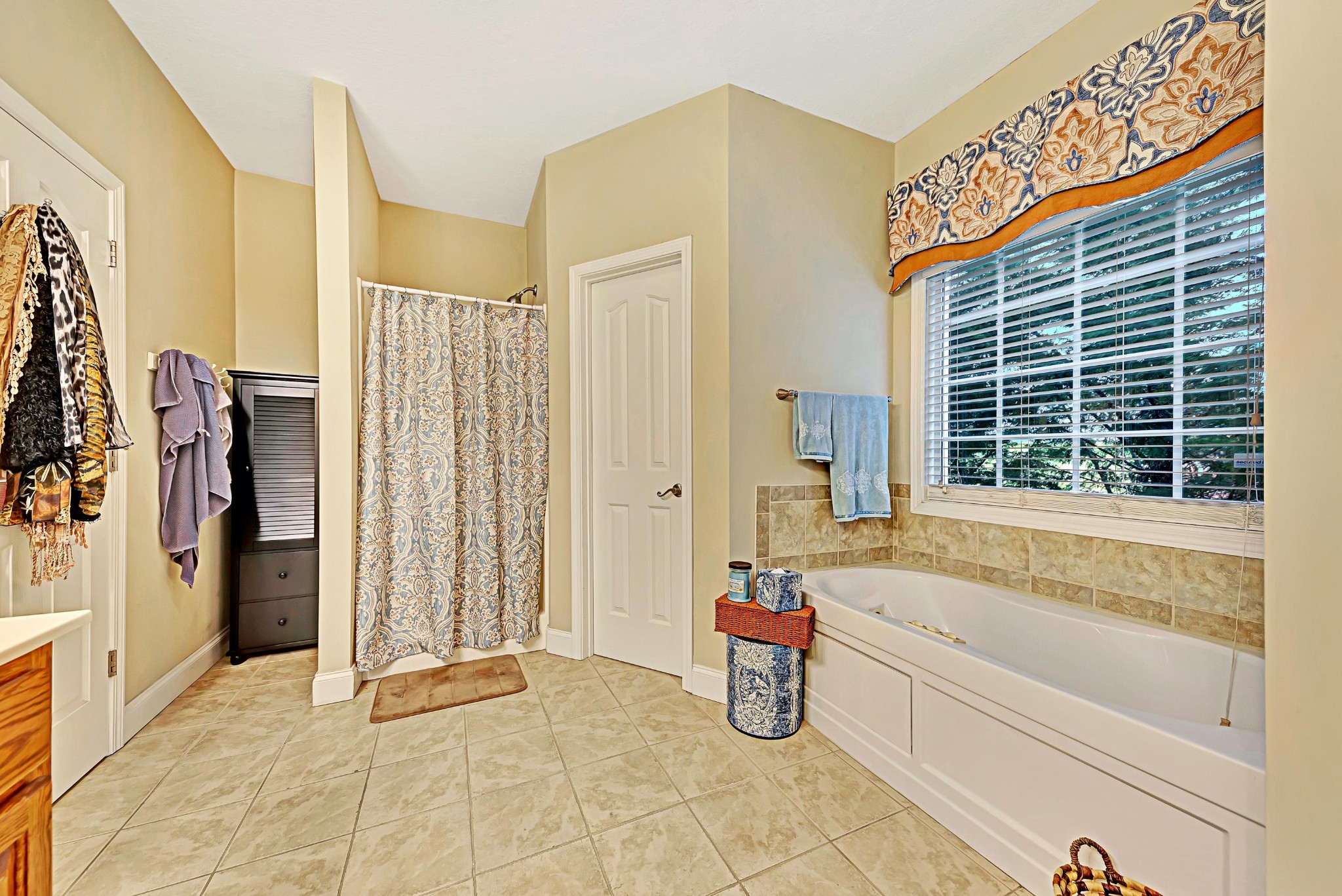 716 Ridgeview Drive Clinton, TN 37716 - Photo 12 of 23 a spacious bathroom with a bathtub and next to a window