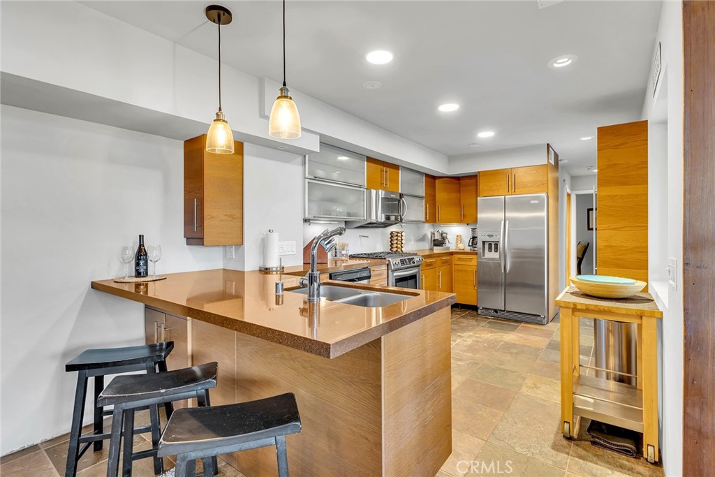 53580 Jeffery Pine Road Idyllwild, CA 92549 - Photo 16 of 61 a kitchen with stainless steel appliances granite countertop a sink a stove and a refrigerator