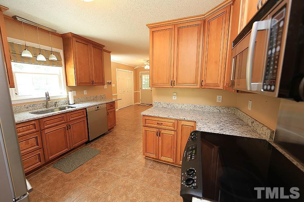 3107 Gold Digger Road Clayton, NC 27520 - Photo 3 of 11 Updated kitchen with tile floors and granite counters. Stainless refrigerator remains