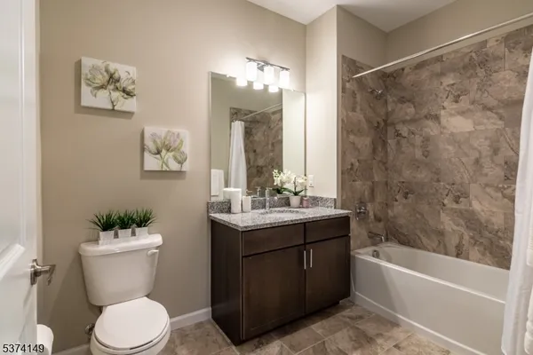 a bathroom with a sink vanity mirror and toilet