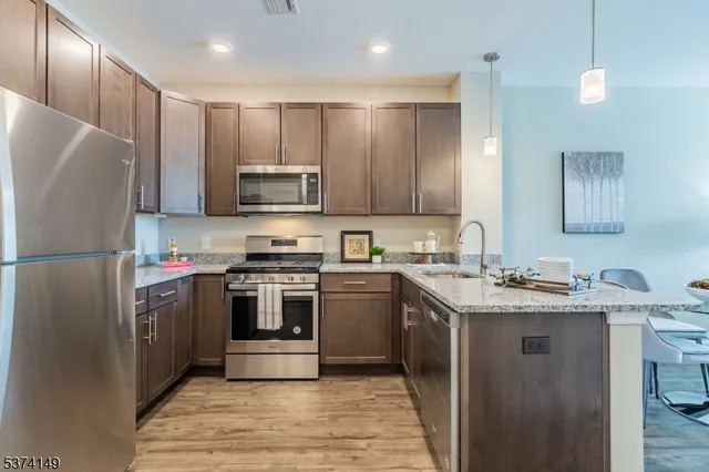 a kitchen with a sink stove and refrigerator