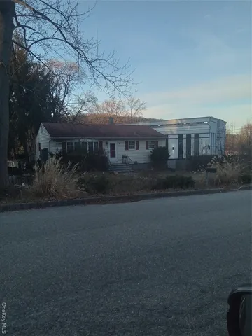 a view of house with outdoor space and a street view