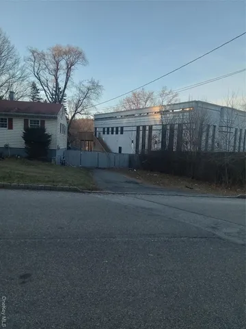 a front view of a house with a yard table and chairs