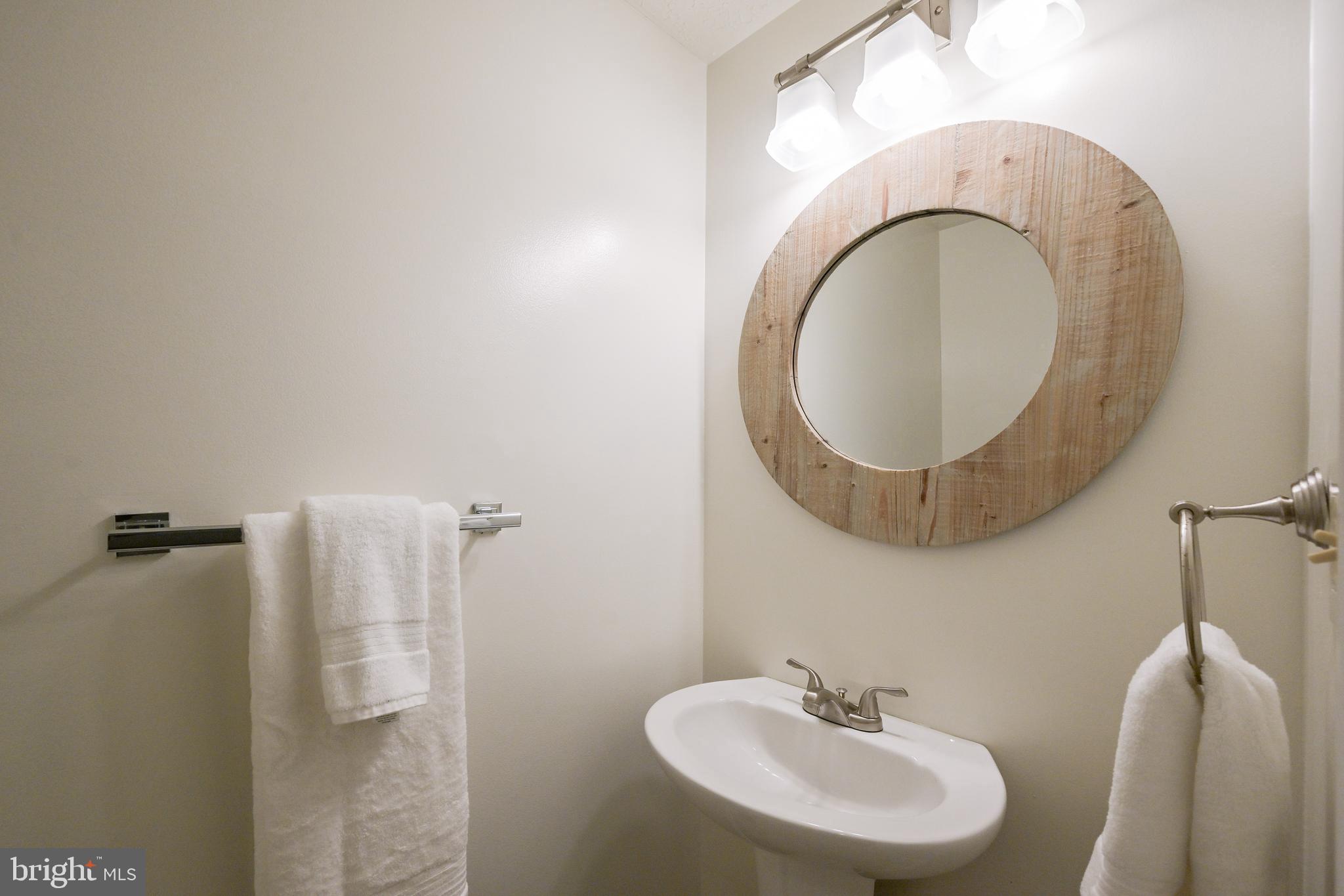 7954 Millstream Court Elkridge, MD 21075 - Photo 22 of 41 a bathroom with a sink and a mirror