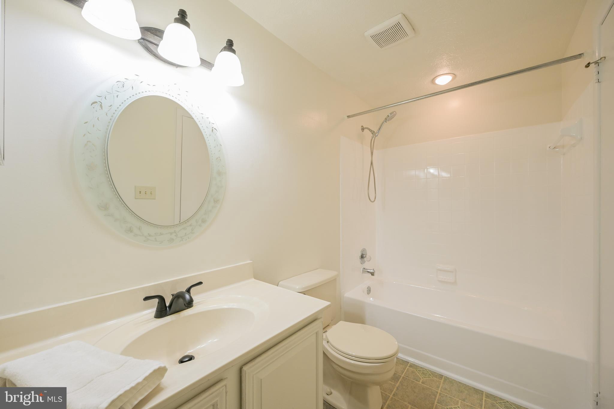 7954 Millstream Court Elkridge, MD 21075 - Photo 27 of 41 a bathroom with a sink a toilet and a mirror