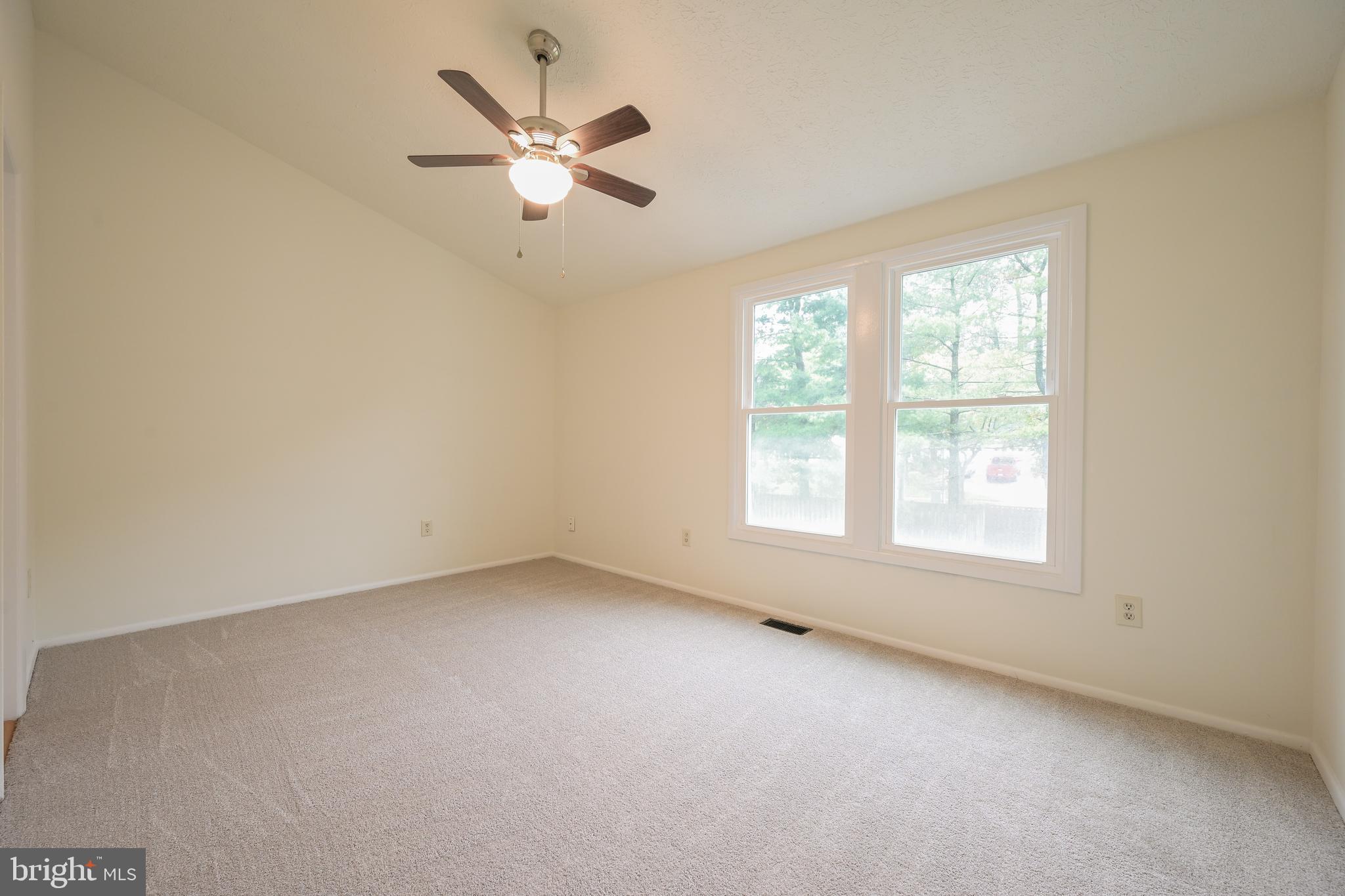 7954 Millstream Court Elkridge, MD 21075 - Photo 28 of 41 an empty room with a window and a fan