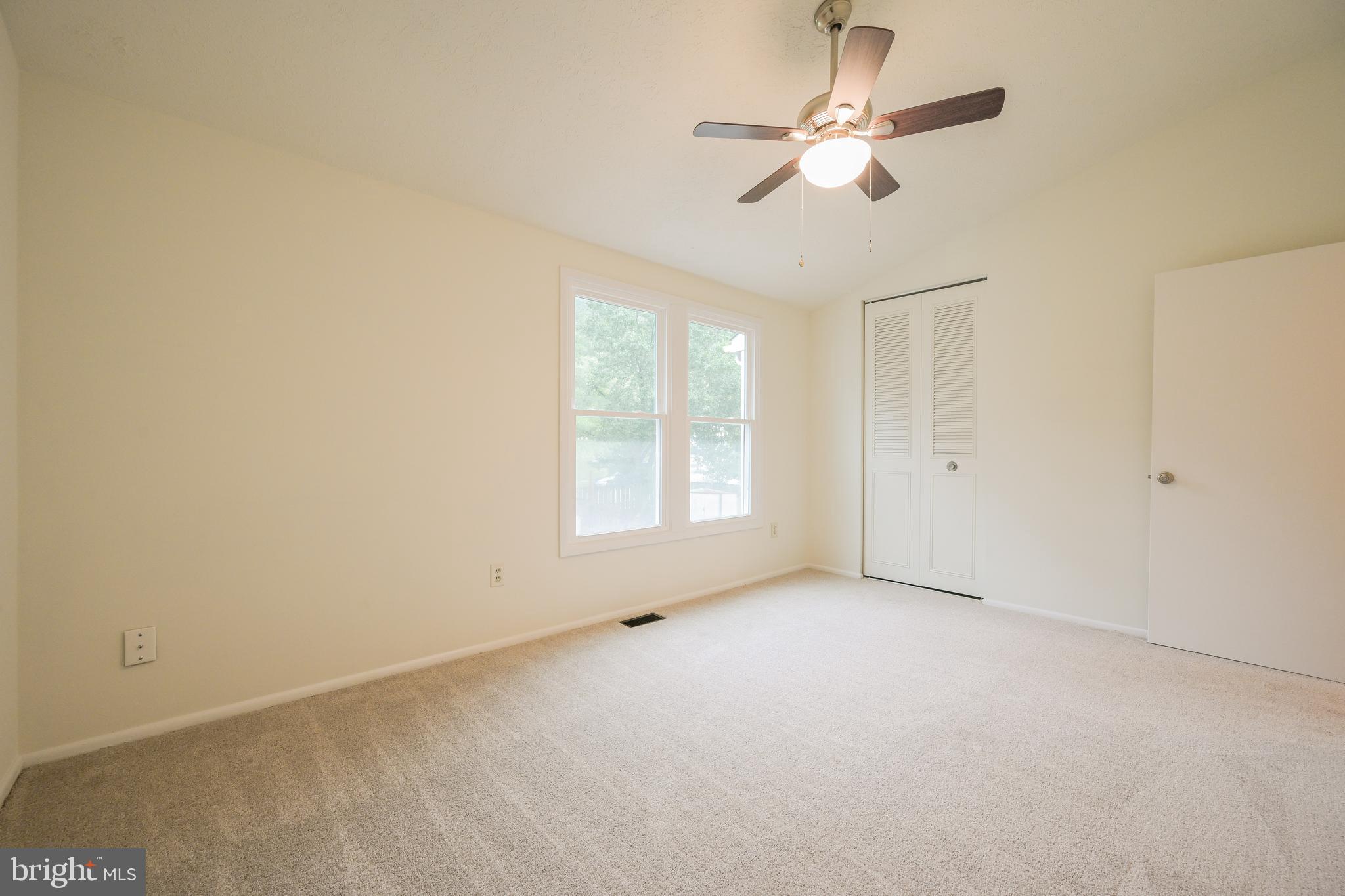 7954 Millstream Court Elkridge, MD 21075 - Photo 31 of 41 an empty room with a window and a ceiling fan