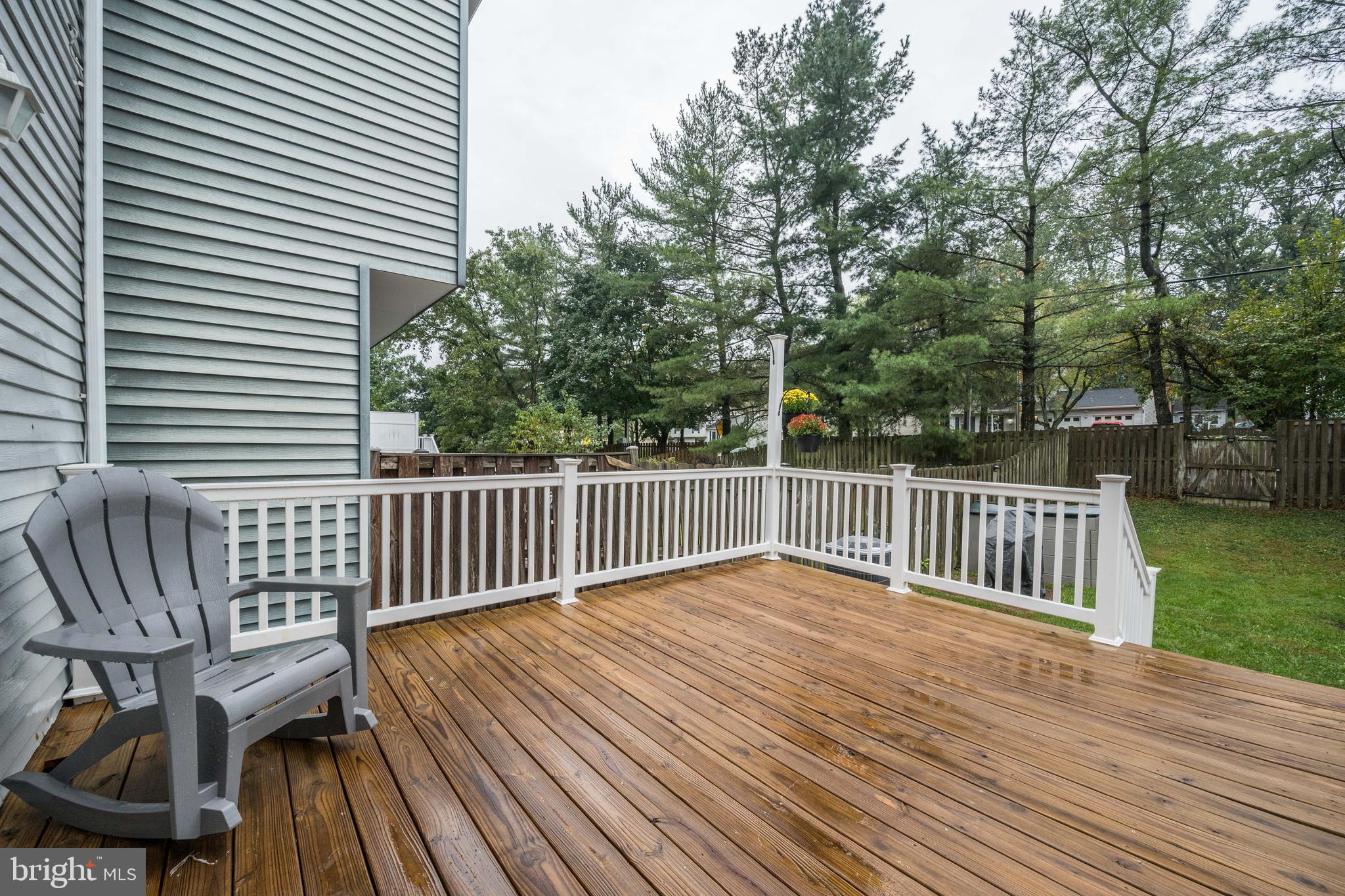 7954 Millstream Court Elkridge, MD 21075 - Photo 40 of 41 a view of deck with a table and chairs with wooden floor and fence