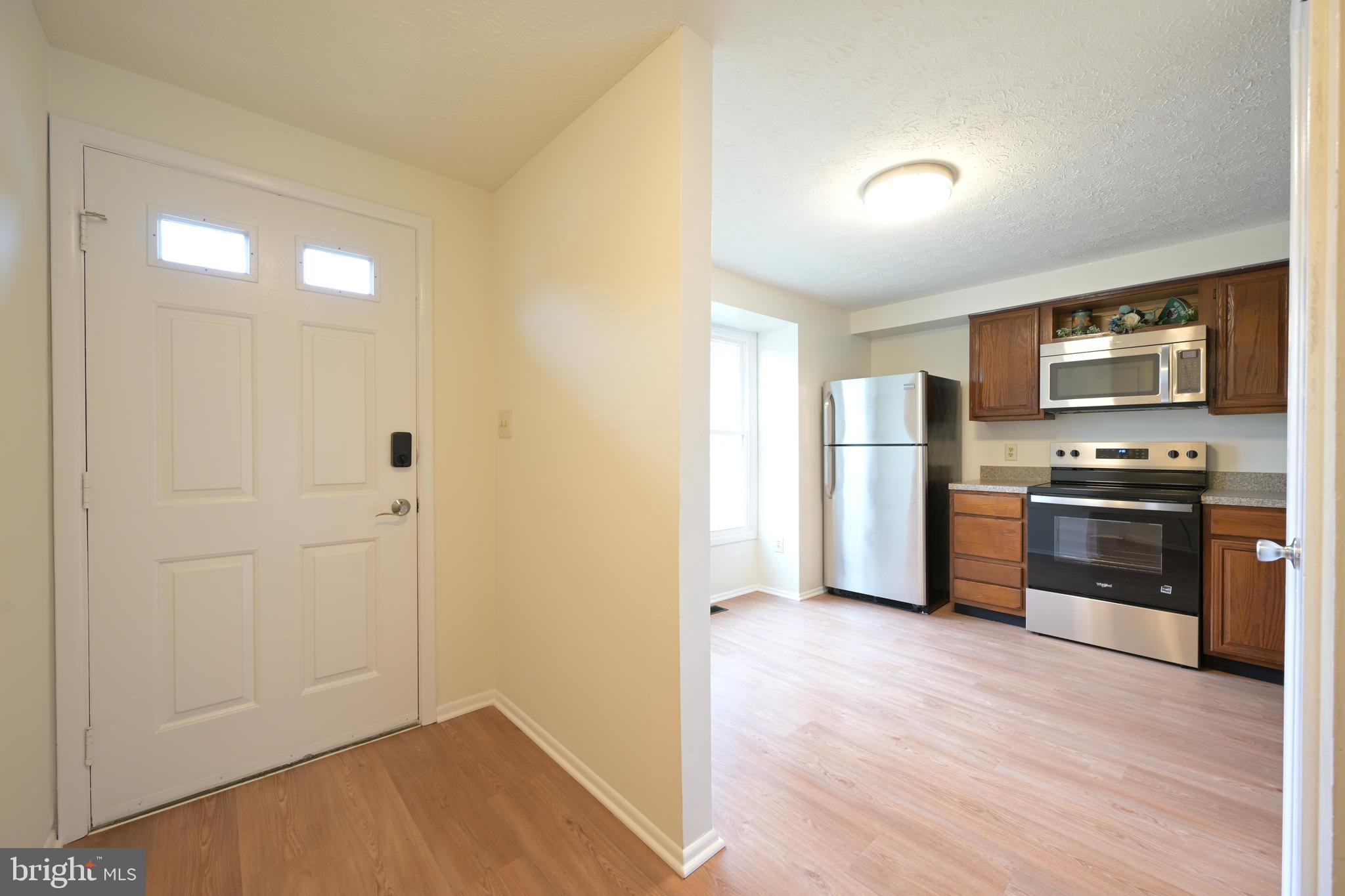 7954 Millstream Court Elkridge, MD 21075 - Photo 9 of 41 a kitchen with stainless steel appliances a refrigerator and a stove top oven