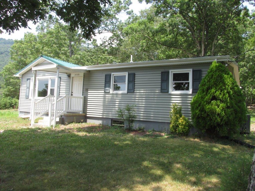 3779 Flatwoods Road Elliston, VA 24087 - Photo 1 of 21 a front view of a house with a garden
