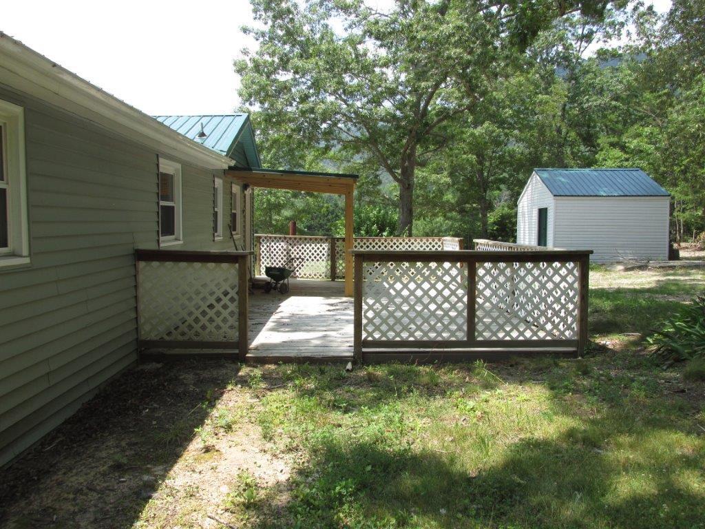3779 Flatwoods Road Elliston, VA 24087 - Photo 16 of 21 a wooden bench sitting in the middle of a yard