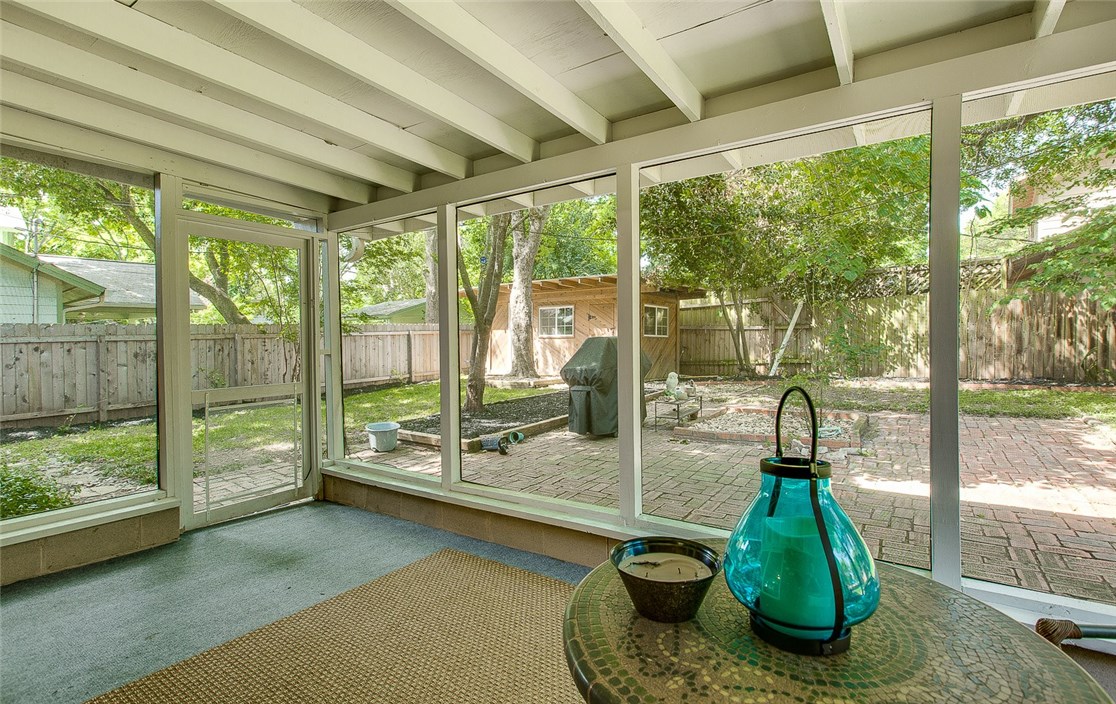 6708 Lexington Road Austin, TX 78757 - Photo 1 of 1 a living room with a floor to ceiling window and floor to ceiling window