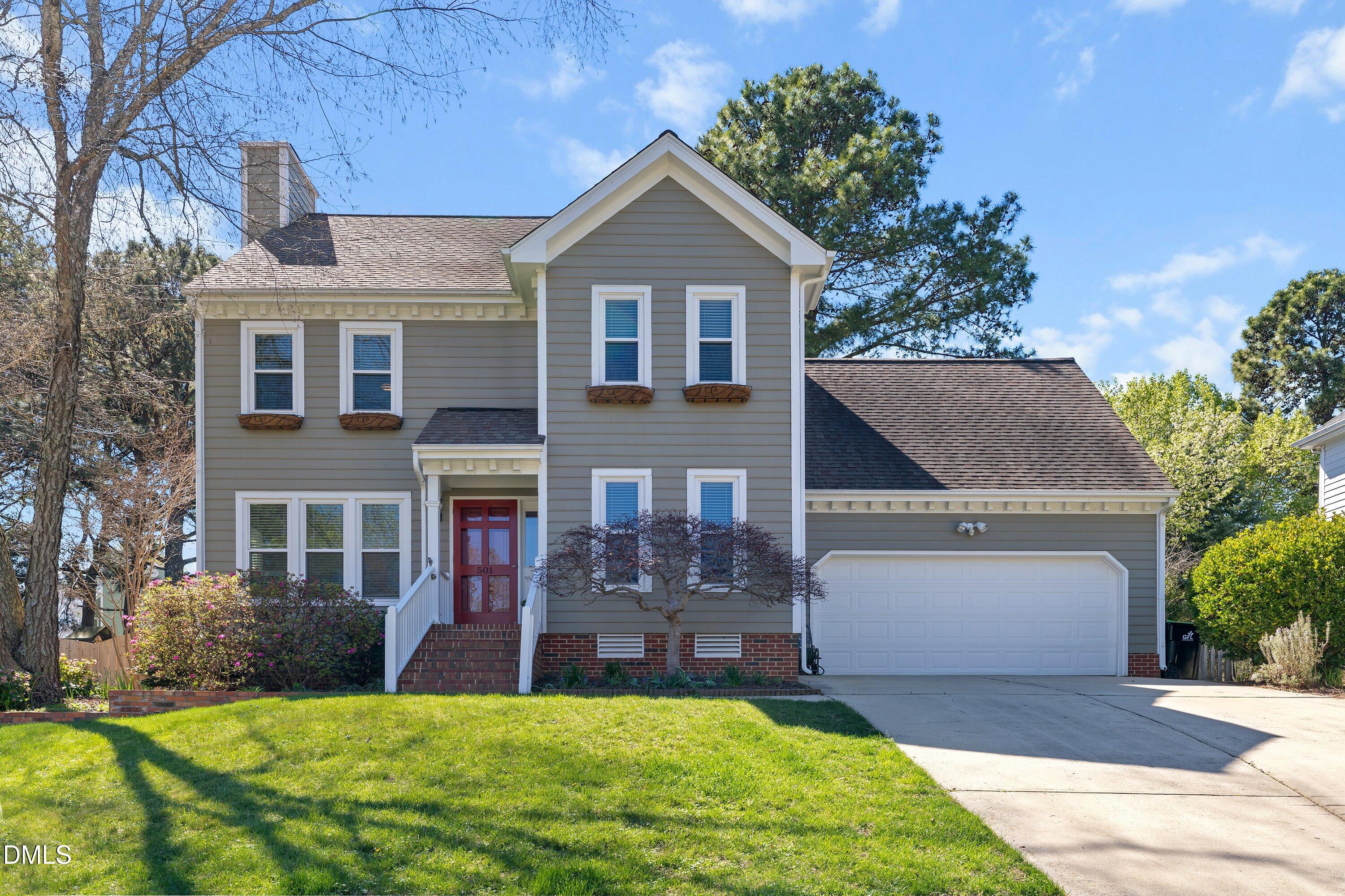 501 Samara Street Apex, NC 27502 - Photo 1 of 77 a front view of a house with a yard and garage