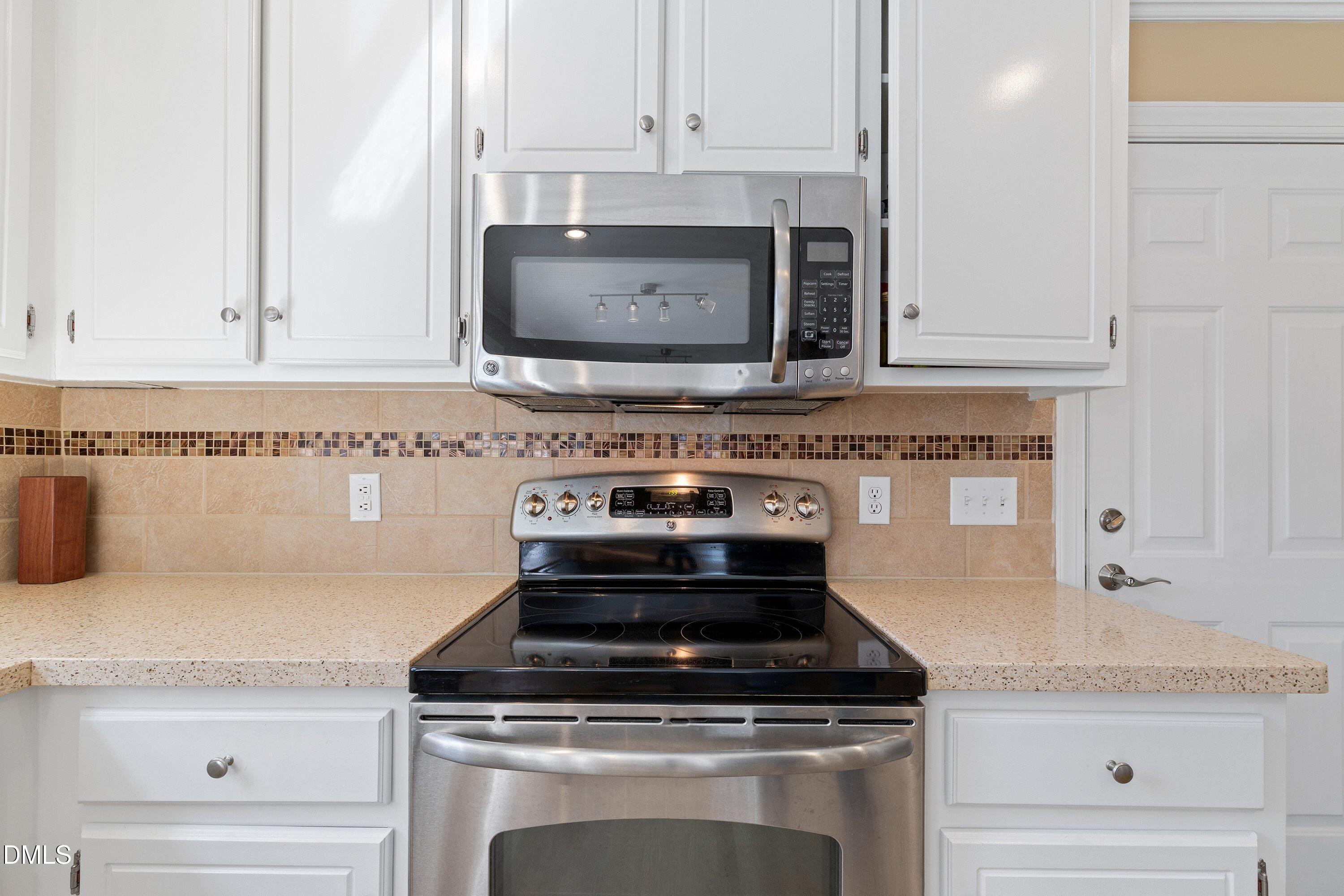501 Samara Street Apex, NC 27502 - Photo 17 of 77 a stove top oven sitting inside of a kitchen