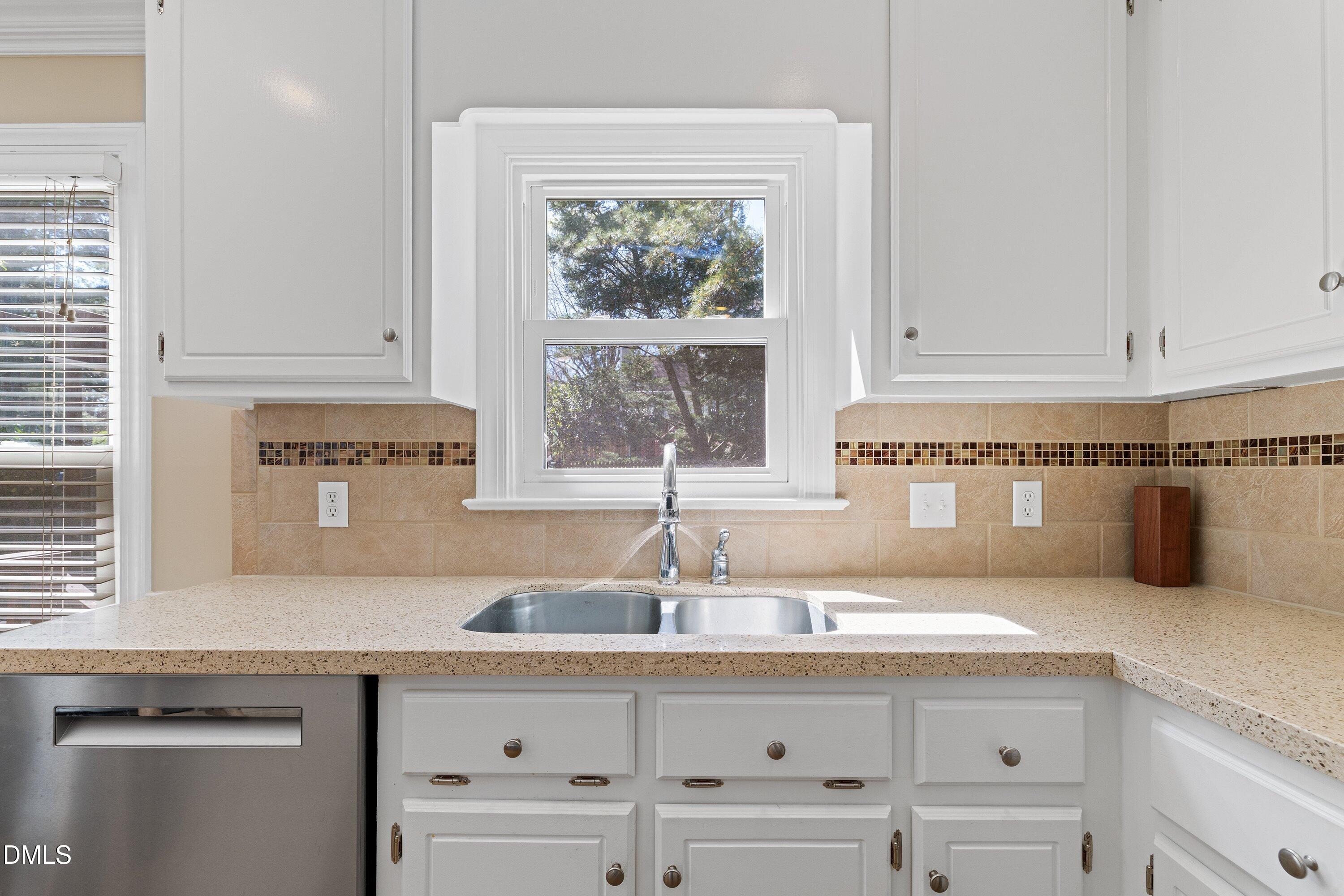 501 Samara Street Apex, NC 27502 - Photo 18 of 77 a kitchen with granite countertop a sink and a window