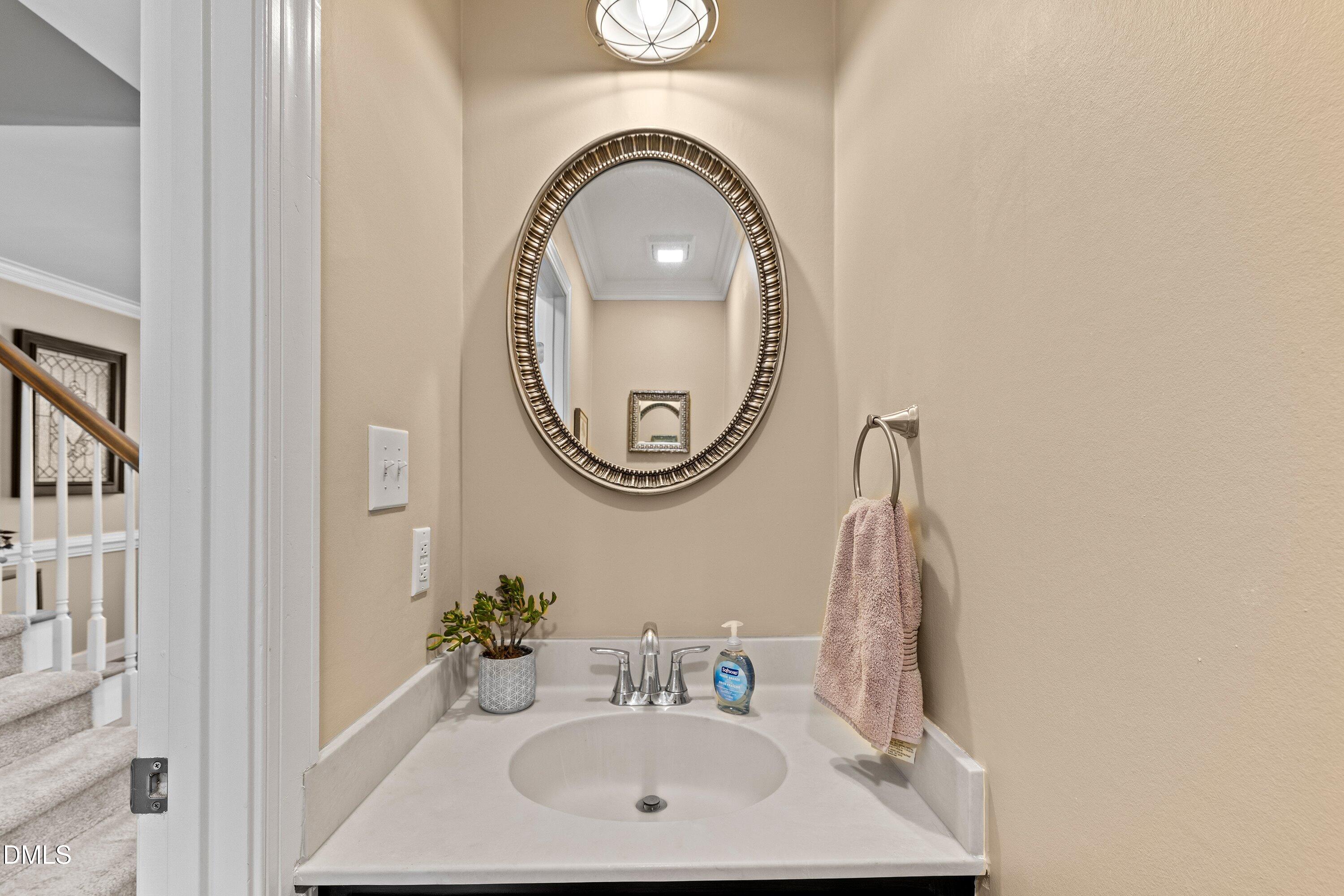 501 Samara Street Apex, NC 27502 - Photo 23 of 77 a bathroom with a sink and a mirror