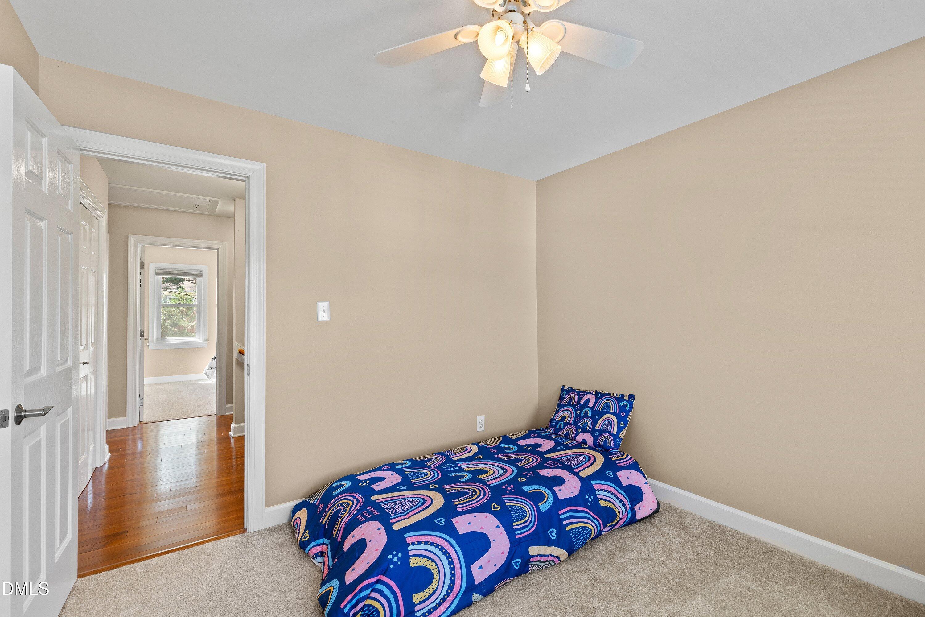 501 Samara Street Apex, NC 27502 - Photo 25 of 77 a bedroom with a bed and a chandelier