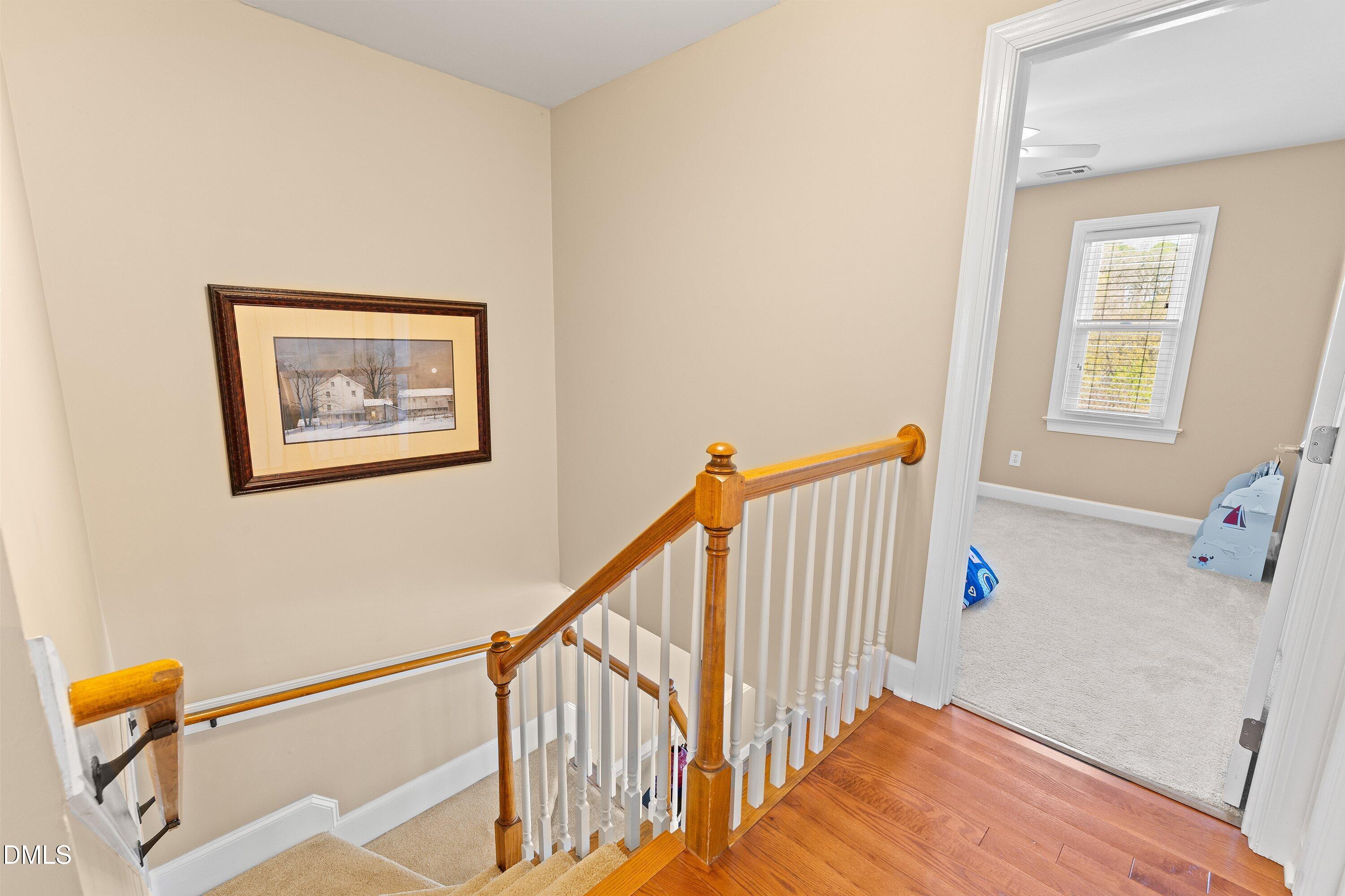 501 Samara Street Apex, NC 27502 - Photo 26 of 77 a view of entryway with stairs and wooden floor