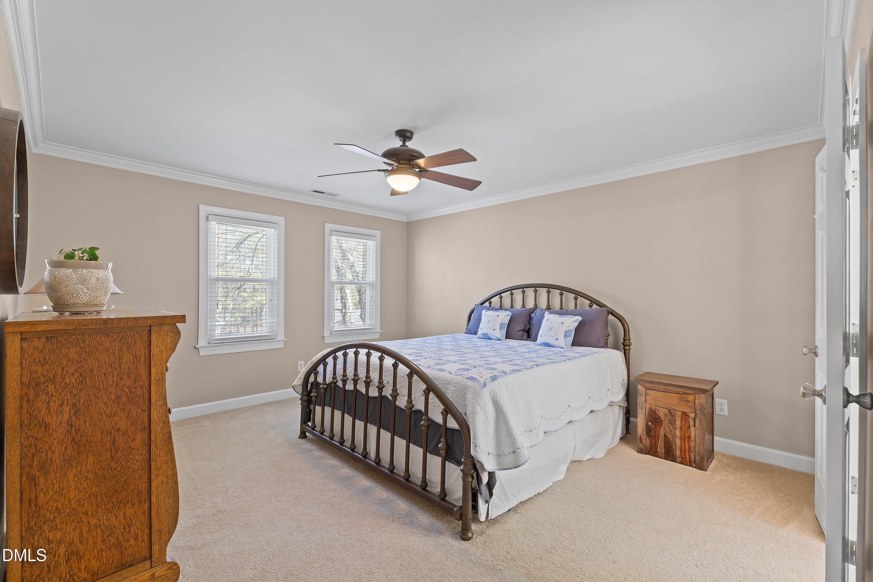 501 Samara Street Apex, NC 27502 - Photo 28 of 77 a bed sitting in a bedroom next to a window