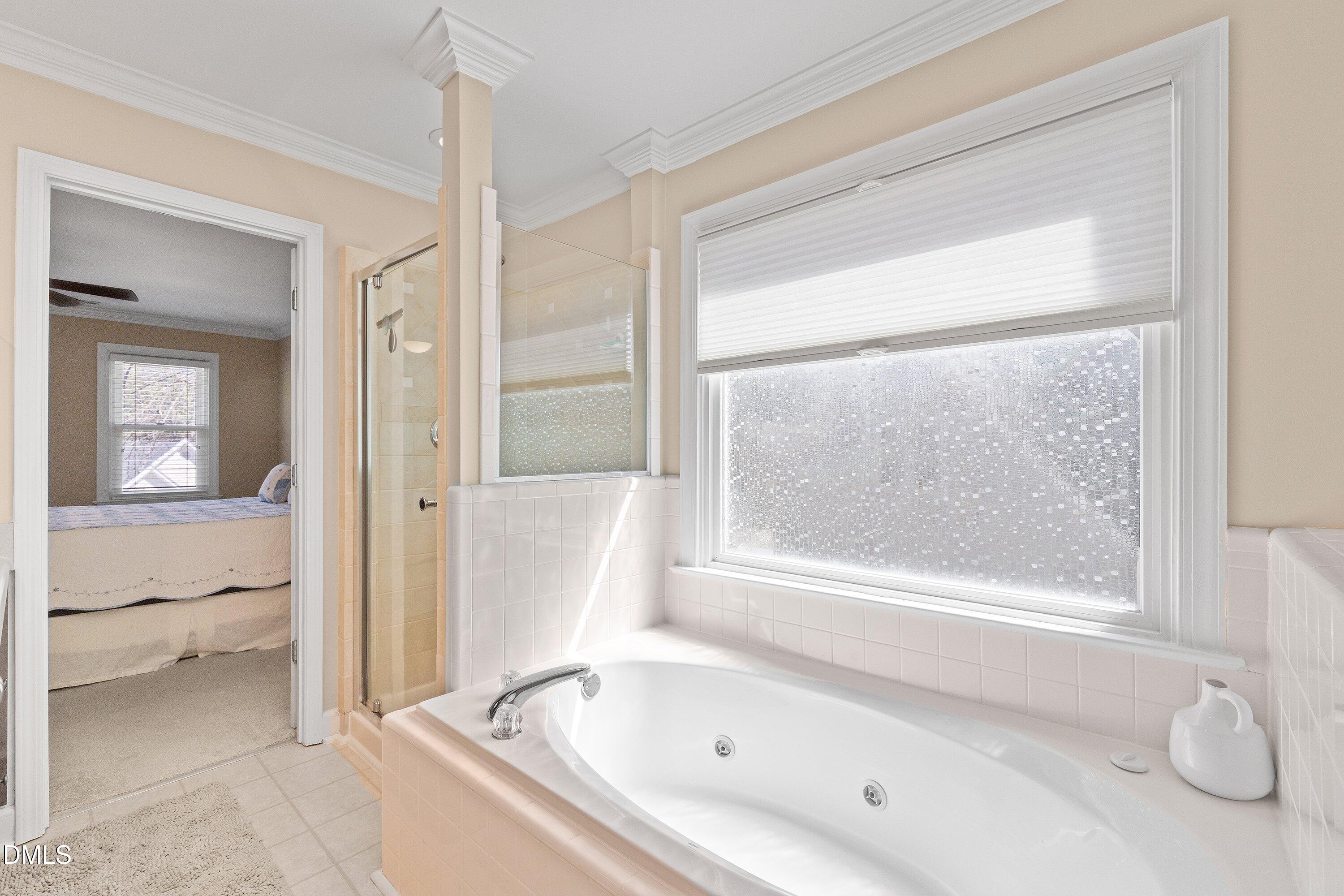 501 Samara Street Apex, NC 27502 - Photo 34 of 77 a bathroom with a bathtub and a shower