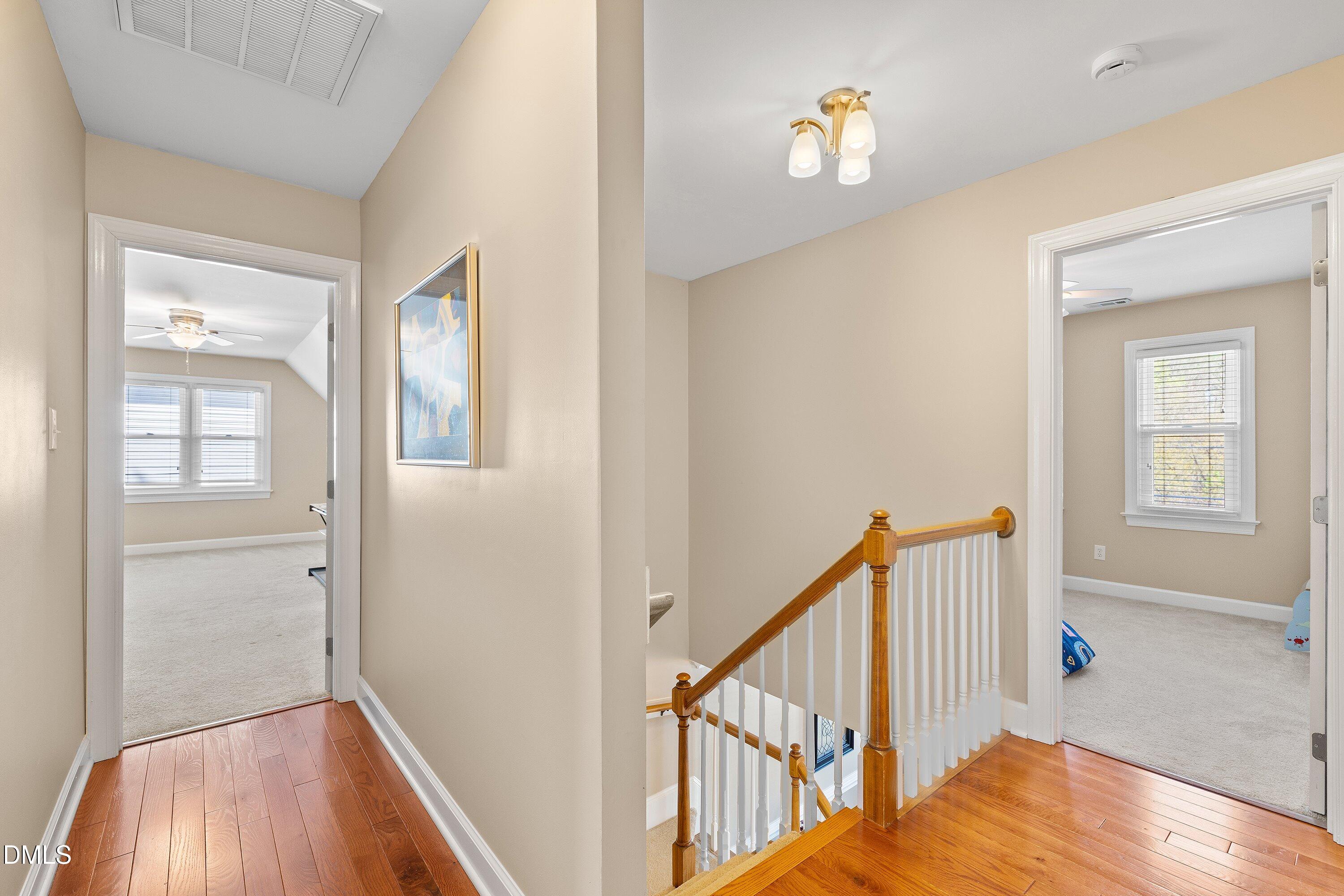 501 Samara Street Apex, NC 27502 - Photo 36 of 77 a view of a hallway with wooden floor and stairs