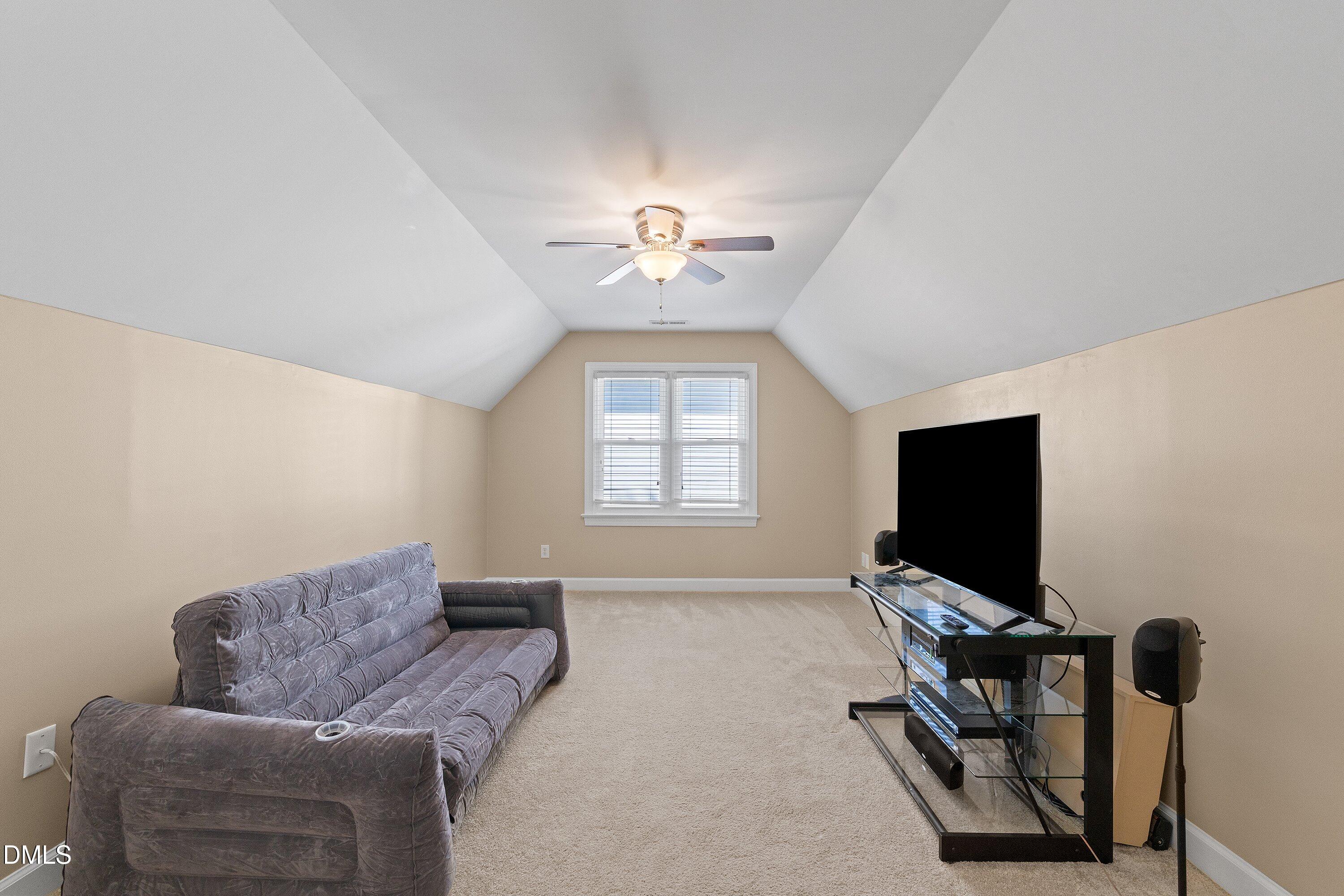 501 Samara Street Apex, NC 27502 - Photo 40 of 77 a living room with furniture and a flat screen tv