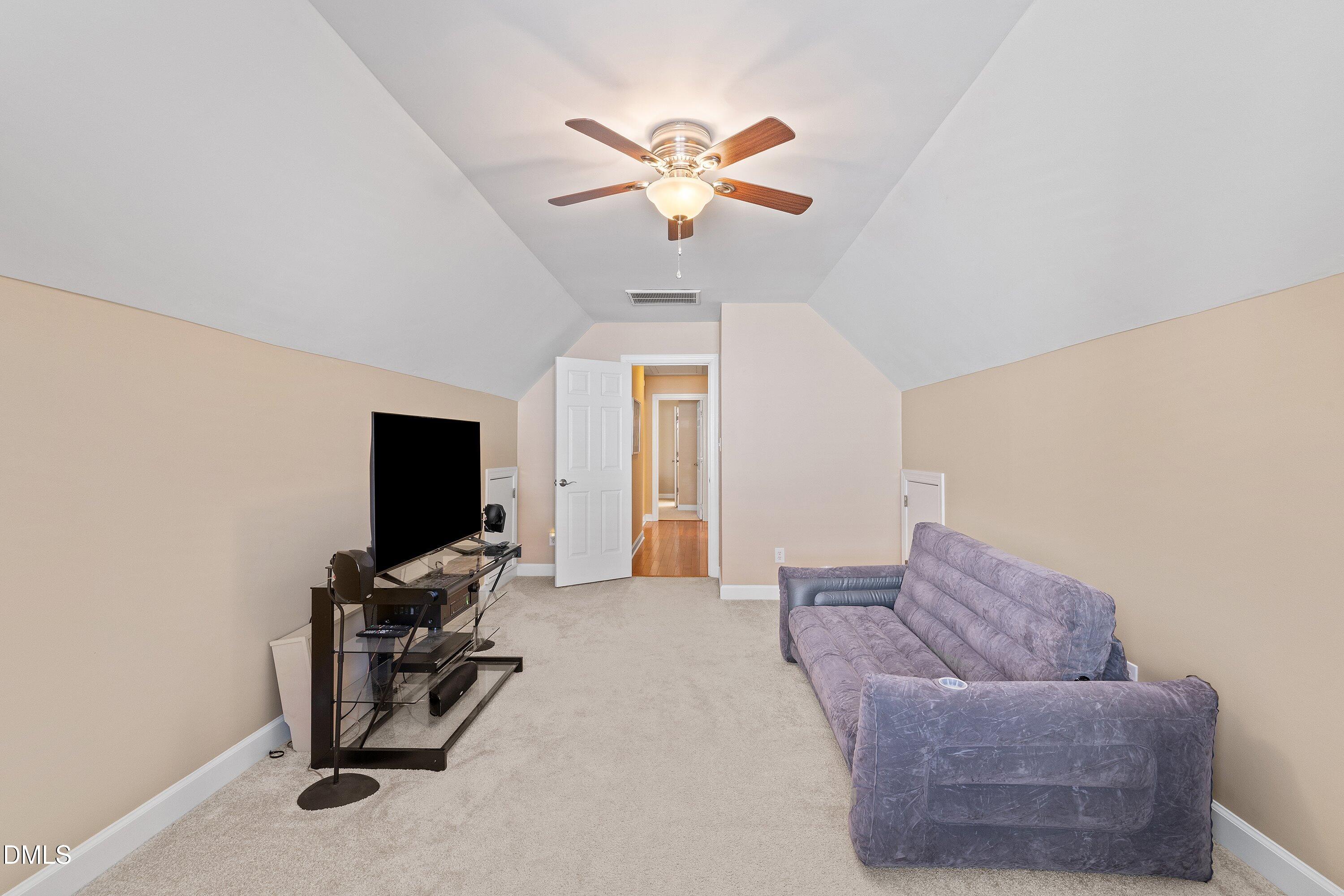 501 Samara Street Apex, NC 27502 - Photo 41 of 77 a living room with furniture and a flat screen tv