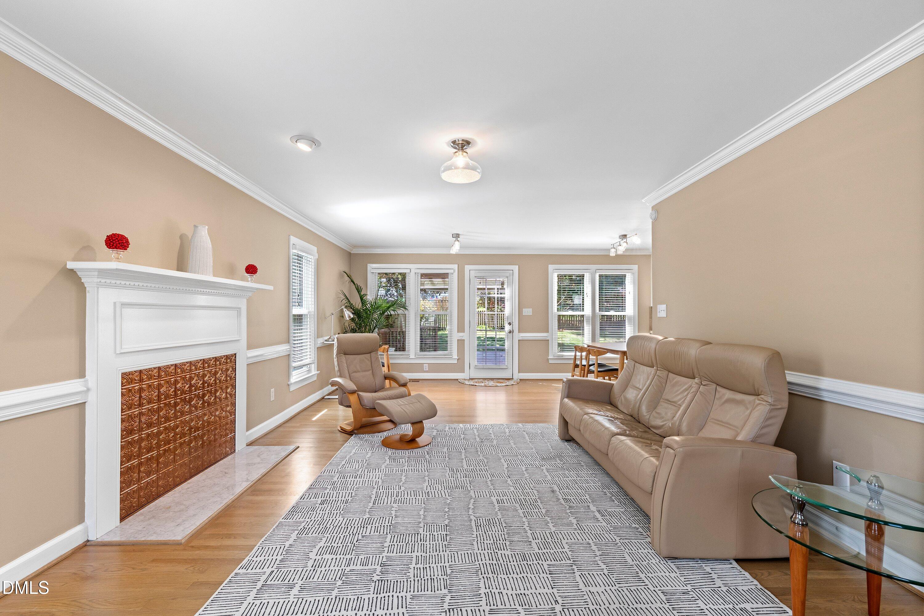501 Samara Street Apex, NC 27502 - Photo 5 of 77 a living room with furniture and a fireplace