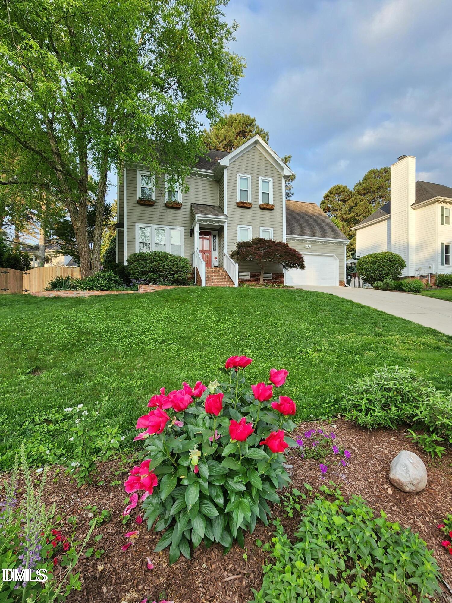 501 Samara Street Apex, NC 27502 - Photo 51 of 77 a front view of a house with a big yard and a large tree