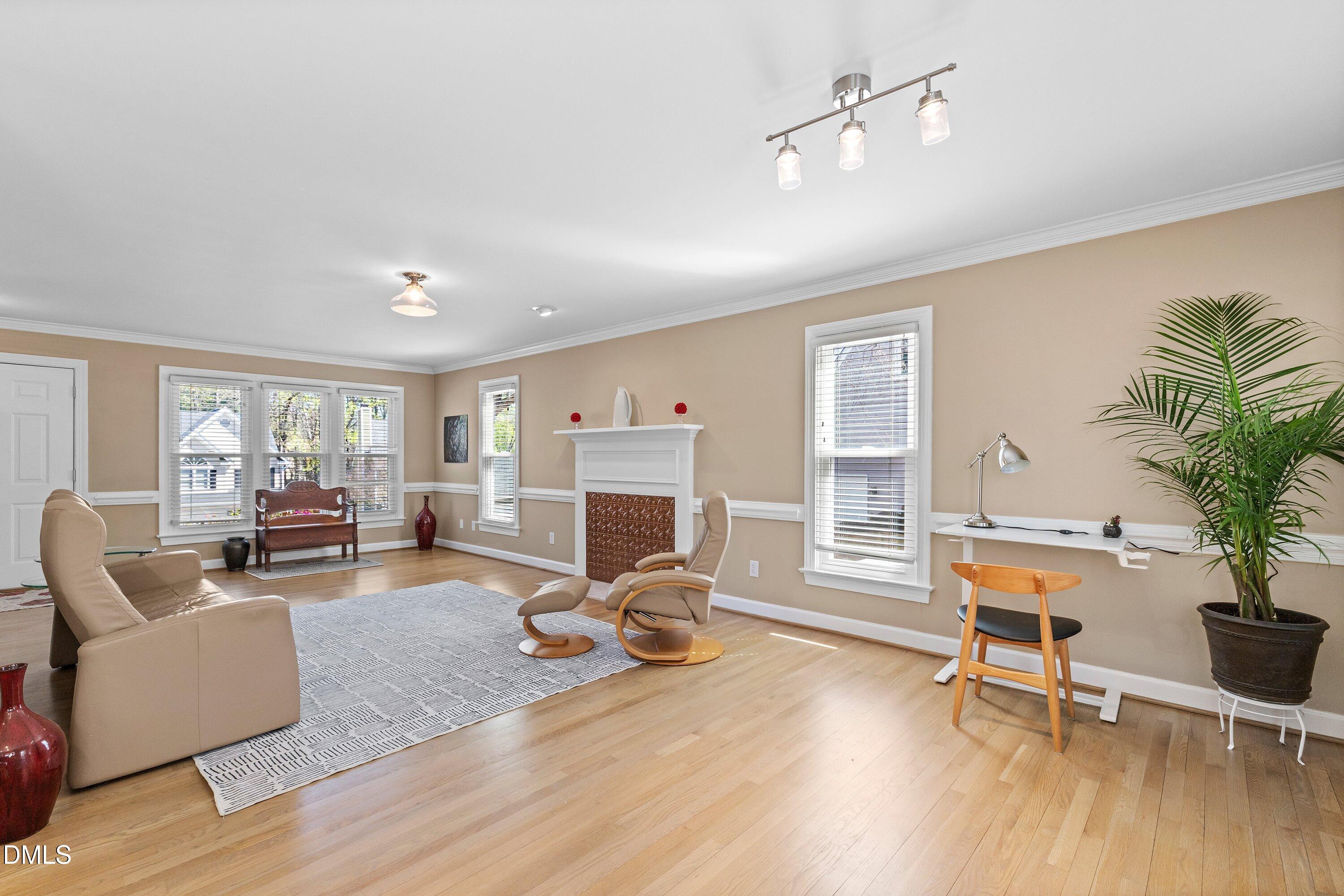 501 Samara Street Apex, NC 27502 - Photo 7 of 77 a living room with furniture gym equipment and a large window