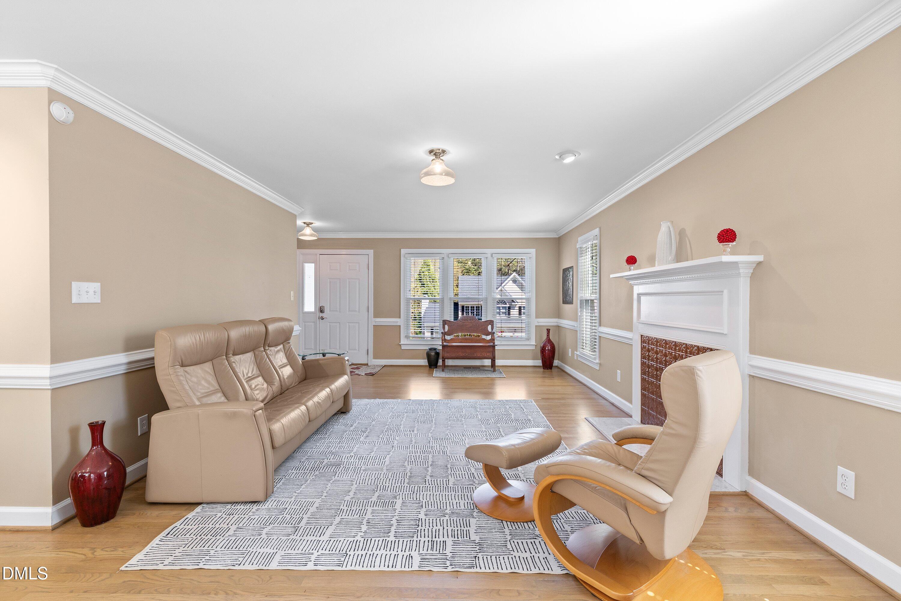 501 Samara Street Apex, NC 27502 - Photo 8 of 77 a living room with furniture and a fireplace