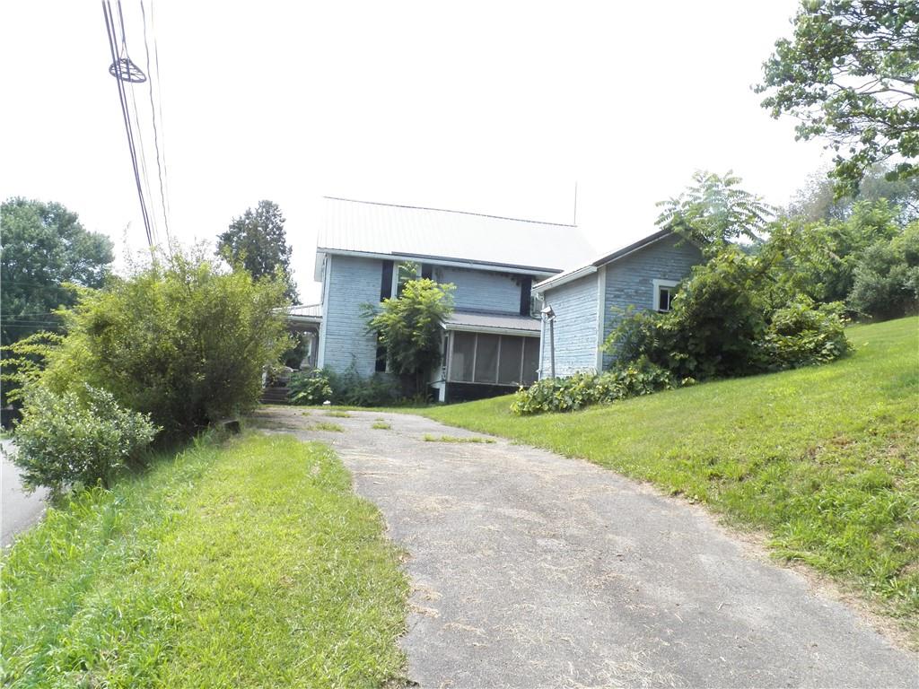 555 MADISON Road Templeton, PA 16259 - Photo 22 of 24 a front view of a house with a yard and garage