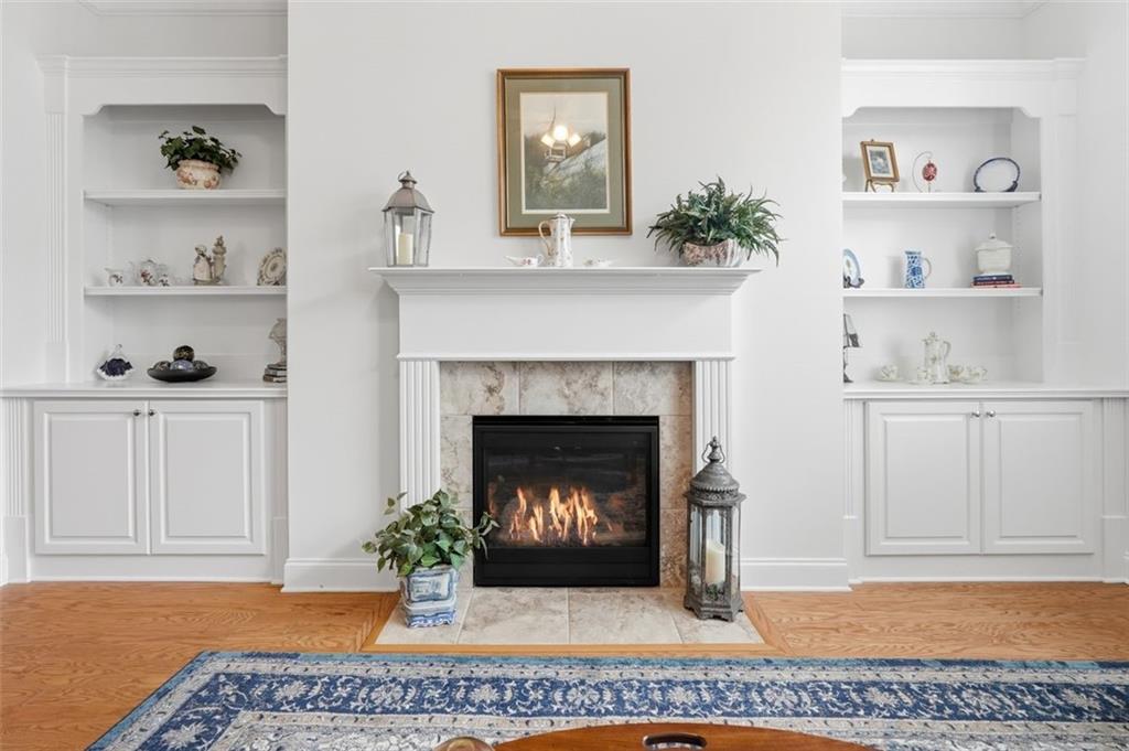 3328 Ivy Ridge Court Buford, GA 30519 - Photo 14 of 34 a living room with a fireplace and wooden floor