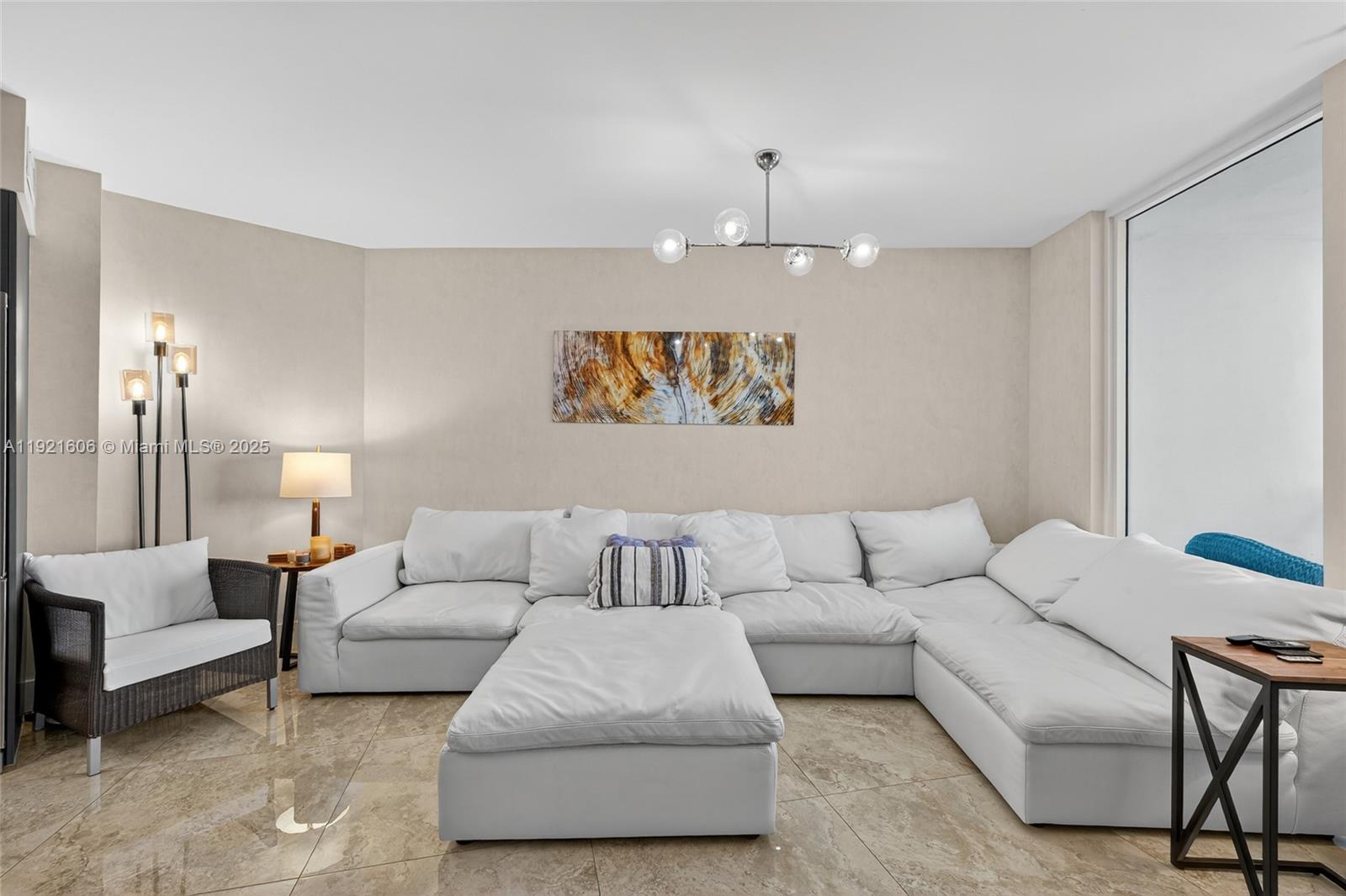 9821 East Bay Harbor Drive, Unit 402 Bay Harbor Islands, FL 33154 - Photo 11 of 34 a living room with furniture and a lamp