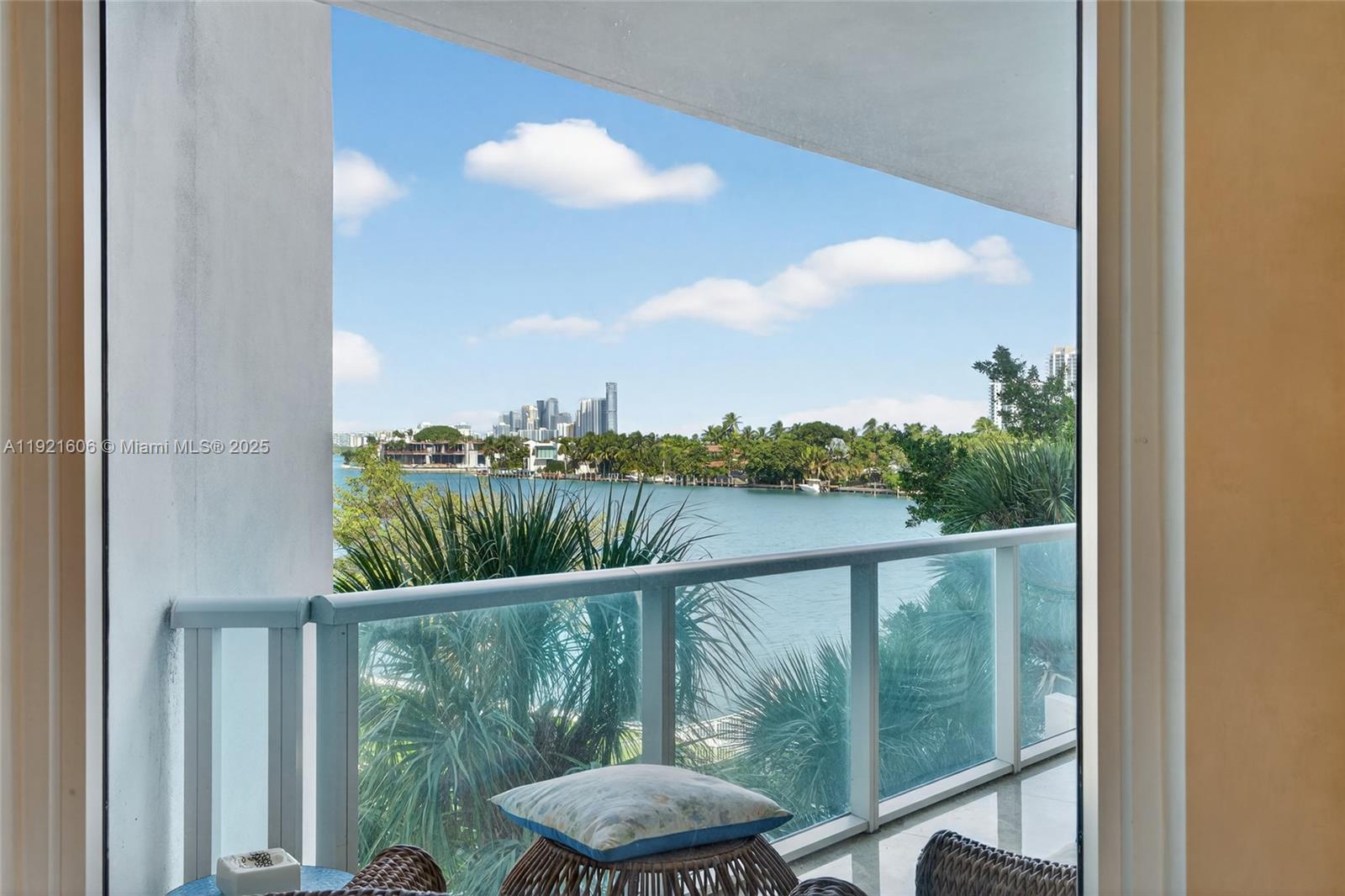 9821 East Bay Harbor Drive, Unit 402 Bay Harbor Islands, FL 33154 - Photo 12 of 34 a view of a balcony with chair and wooden floor