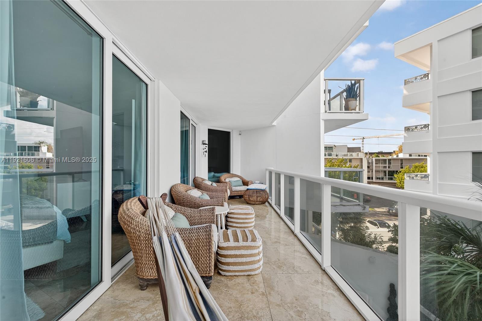 9821 East Bay Harbor Drive, Unit 402 Bay Harbor Islands, FL 33154 - Photo 13 of 34 a living room with furniture and a floor to ceiling window